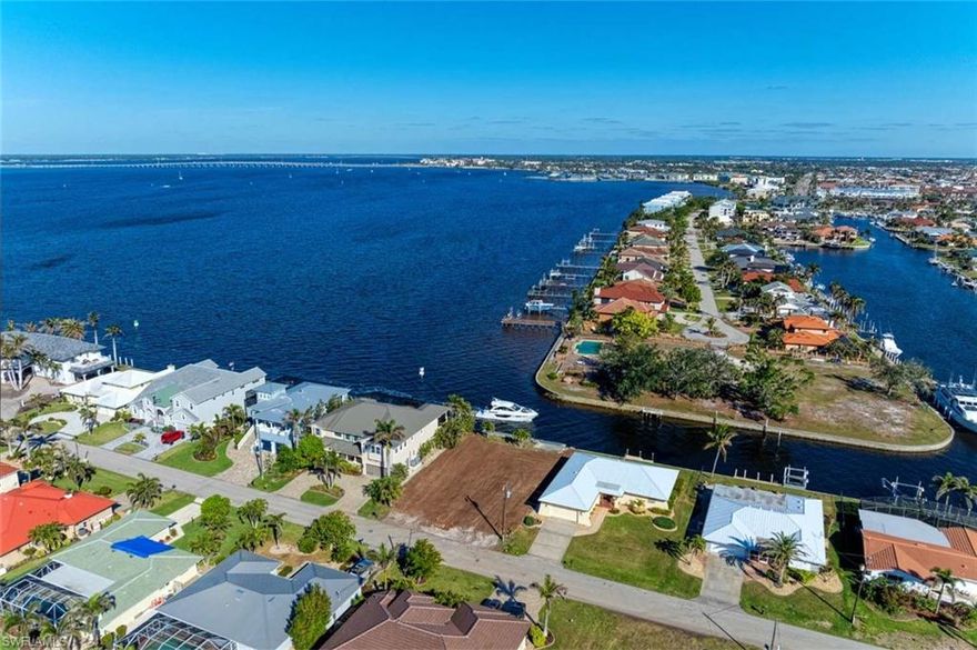 BOATER'S PARADISE AWAITS at this incredible and RARE, SHOVEL-READY oversized lot with newly extended concrete dock with incredible views of Charlotte Harbor and the main canal into the yacht club and the old sailboat section of Punta Gorda Isles. Existing building plans are available and will save you 6 months in the process to build your dream home here, amidst other $3,000,000+ homes! Owners' plans changed, so this opportunity is for YOU! Be sure to check out the video and ask for the plans and newly completed survey to secure this property today! It is nearby to Ponce Park, Fishermen's Village, the Isles Yacht Club, local golf, all things Downtown Punta Gorda including farmer's markets weekly, great arts and music festivals, fabulous restaurants, and more, with world class boating access via a city-maintained canal with city owned concrete seawalls and great deep-water access for your vessel. Just a short ride to the Gulf, this property has it all! Check it out today!