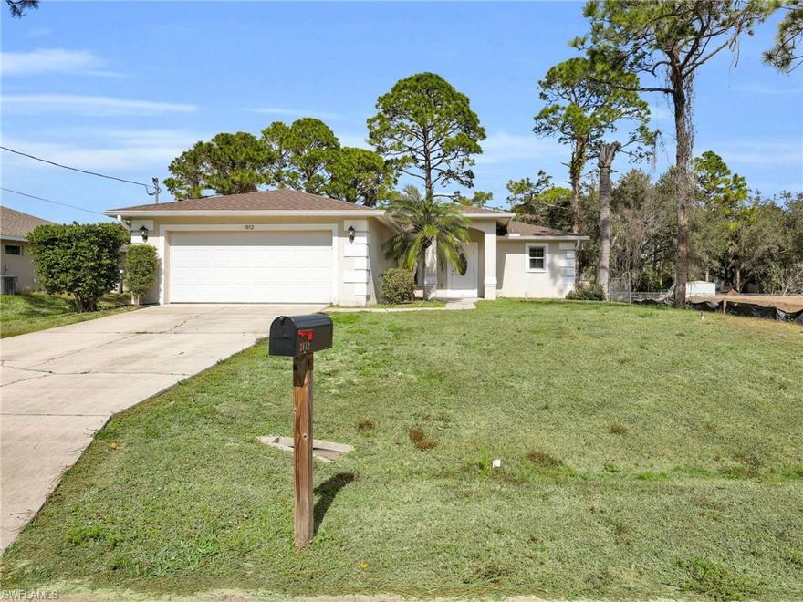 This single family home offers three bedrooms, two bathrooms, and a two car garage with a practical layout and consistent finishes throughout. Recent updates include a new roof installed in 2021, a new AC system installed in 2024, and a water filtration system added in 2025 along with a new well system and pump completed in 2025. The interior features tile flooring in every room, providing a clean and uniform look that is easy to maintain and well suited for daily living. The main living area is centrally positioned and connects directly to the screened in lanai through sliding glass doors, allowing for a smooth transition between indoor and outdoor space. The lanai is fully screened and overlooks the fenced in backyard, offering a defined outdoor area while maintaining privacy. The kitchen is designed with functionality in mind and includes stainless steel appliances, ample countertop space, and a generous amount of cabinetry for storage. The layout allows for efficient use of space and easy access to the main living area, keeping the home’s primary spaces well connected. All three bedrooms are finished with tile flooring to match the rest of the home, creating a consistent appearance throughout. The primary bedroom includes an en suite bathroom, while the remaining two bedrooms are located near the second full bathroom, offering a straightforward and accessible layout. The exterior of the property includes a fully fenced yard, providing separation from neighboring properties. A fire pit is located within the yard, adding a designated outdoor feature. The lot offers open space while remaining manageable in size. The attached two car garage provides covered parking and additional storage space, with direct access into the home.