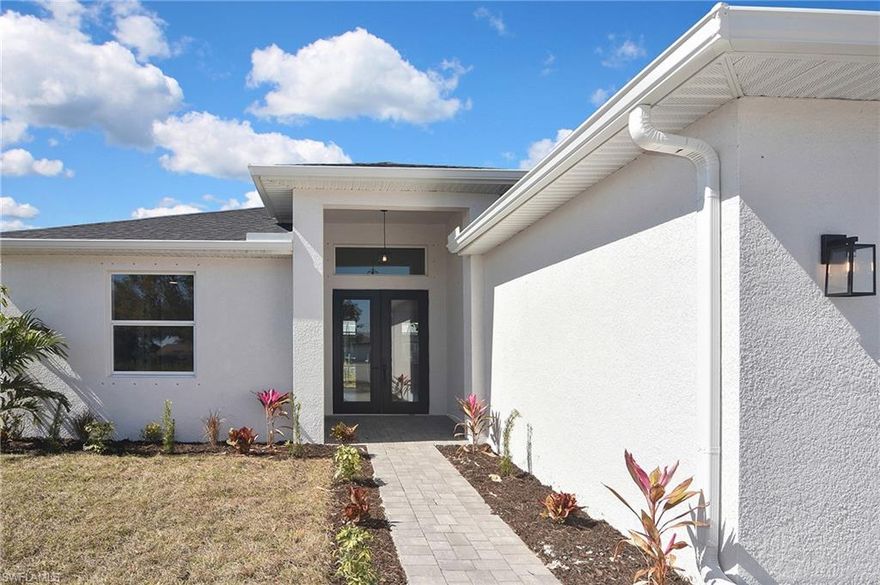 Come view this gorgeous brand-new home nestled in a quiet setting. As backyard is West facing, sunsets won’t be obstructed as a park is coming in across the canal. Enjoy high ceilings & upgraded finishes in this 4 bed, 1,800 SF home. Luxurious showers are made for relaxation. Beautiful pool & spa perfect for entertainment embraces the Florida lifestyle. Tray ceilings in living room & owner suite. Hardwood cabinets, energy efficient windows, granite countertops, tile flooring throughout, paver driveway, impact front door, stainless steel appliances, ceiling fans throughout, removable kid pool fence & ample closet space all make this home an ideal place for a family to call home. No flood insurance required. Several parks nearby. Short drive to Pine Island Rd.