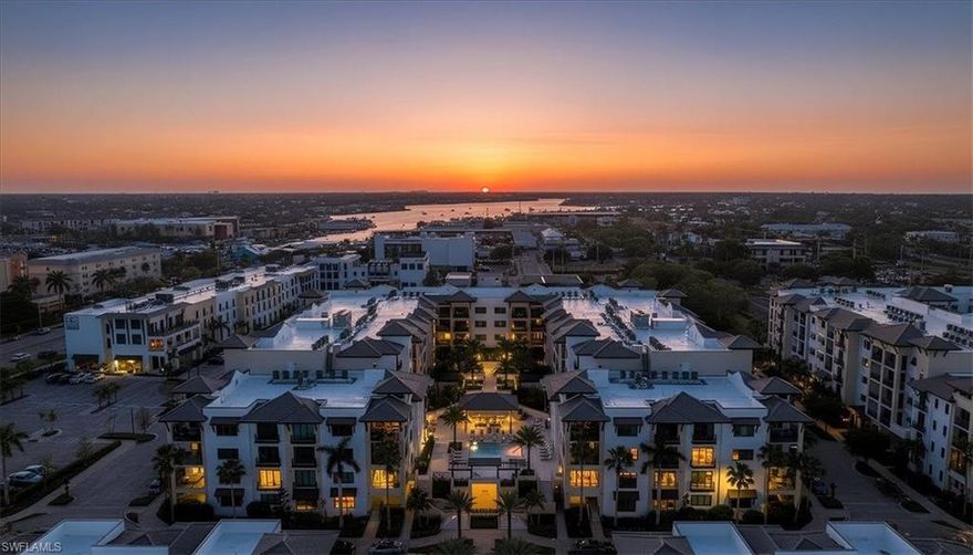 Best-value newer construction in Naples Square! This premium designer-furnished former model with over $485K in upgrades is being offered TURNKEY FURNISHED. Designed to live like a private single-family home this unique lock-and-leave luxury residence is located at Quattro in Naples Square one of Old Naples' most desirable walkable communities. A rare opportunity to step immediately into a fully curated, magazine-worthy home without the wait or expense of designing from scratch.

This residence features a welcoming foyer entrance, soaring 10-foot ceilings, two private balconies, and a bright, open layout ideal for everyday comfort and elegant entertaining. The chef’s kitchen is truly unforgettable, appointed with a full Sub-Zero/Wolf appliance suite, including integrated refrigeration, 5-burner gas cooktop, wall oven, microwave, Miele dishwasher, and a 46-bottle wine cooler. Quartz countertops, Dornbracht fixtures, a Franke sink, and premium Irpina cabinetry with custom storage elevate both beauty and functionality.

Four spacious en-suite bedrooms provide privacy and comfort for family and guests, while the versatile den—featuring a striking iron-and-glass French door wall and custom built-ins—offers the perfect space for a home office, library, or media room. Throughout the residence, Legno Bastone wood flooring, beamed ceilings, designer lighting, custom furnishings, wall coverings, and window treatments reflect exceptional craftsmanship and attention to detail.

The expansive balcony offers added privacy and tranquil courtyard garden views, creating a peaceful outdoor retreat in the heart of downtown. This unit features secure covered parking with space for two vehicles plus a golf cart, Moke, or Vespa—a rare and highly sought-after convenience. Residents of Quattro at Naples Square enjoy resort-style amenities and concierge services, providing effortless living with assistance for dining reservations, spa appointments, and event planning. Just steps away, discover the vibrant energy of 5th Avenue South, world-class dining, boutique shopping, entertainment, and the sugar-sand beaches of Old Naples.

Masterfully upgraded, this impeccably positioned residence presents a rare and time-sensitive opportunity to secure one of Old Naples’ most sophisticated, move-in-ready luxury offerings.