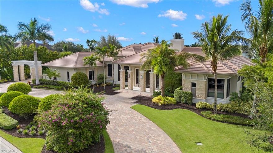 The visually stunning former Adderley model by McGarvey Custom Homes features 6,128 square feet of wondrous living space. Nestled in the Naples golf community of Quail West, this home provides the quintessential luxury indoor/outdoor living experience. Superbly designed layout showcasing multiple entertaining areas and views of the many water features, pool and Lakes Golf Course. Natural light fills the home via floor-to-ceiling windows and sliding glass pocket doors. Beautiful custom-designed asymmetrical fireplace. Unique floating ceilings with ambient cove lighting creates visual separation between the open living spaces. Formal dining room sized for lavish entertaining, a spectacular U-shaped bar, and glass enclosed walk-in wine room. 4 spacious bedrooms, 4 baths, 2 half baths, massive double-island kitchen, den/office, three-car air-conditioned garage plus a separate dedicated golf cart garage. Enormous outdoor living includes kitchen, bar, dining, and TV area with two-sided fireplace. Multi-tiered water features, floating walkway to the custom pool, edgeless spa and chaise shelf. Sunken seating area with fire pit. Complete with screens and hurricane shutters. Welcome home!