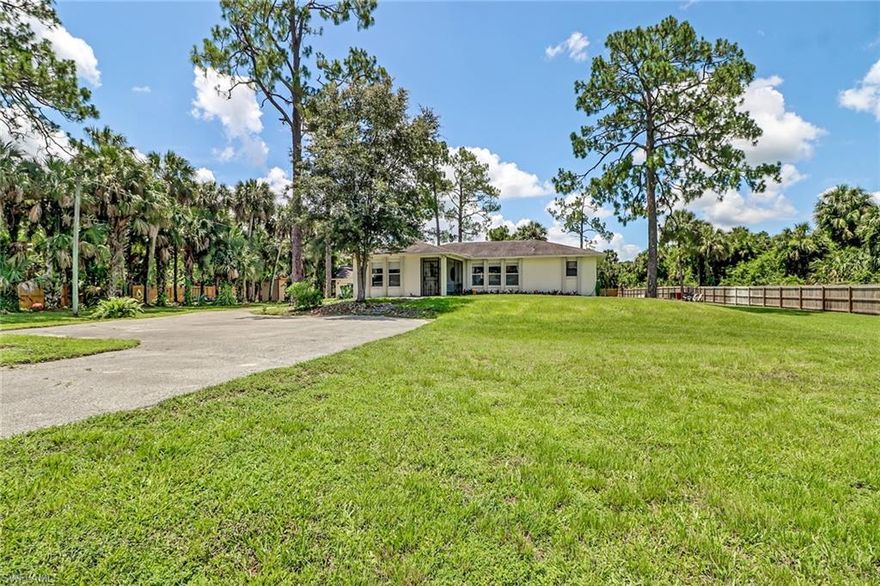 Amazing location, off Wilson and 5 min to Publix! Vanderbilt RD is getting extended putting this home in what will be the most desirable location in Golden Gate Estates.  A very small section of the backyard (sketch available)  will be taken for this purpose. Compensation will be provided! Important home systems have all recently been replaced: roof is 6 years, AC is 4 years old, water heater 5 years, and drain field replaced 1 year ago! This is a charming country home on a super size lot that is 2.73 acres! The home has been updated with stylish dark floors, kitchen cabinets and newer stainless steel appliances. Featuring a highly desirable open concept that will allow you to take advantage of every sq ft on this home. Your kids and/or pets can run freely on this 100% cleared and irrigated lot with beautiful palm and pine trees. The property offers the convenience of a detached garage; great for parking your cars or extra storage.