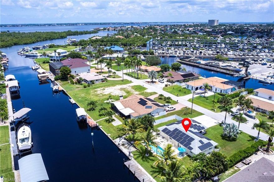 ATTENTION BOATERS!! LOT $256,000 less expensive, than other buildable lots in the area. *RECEIVE A FREE 3BD/2BA SINGLE FAMILY HOME W/POTENTIAL PASSIVE INCOME, NO HOA restrictions! Situated on a "DEEP WATER" "DIRECT GULF ACCESS" LOT W/100 FT OF SEAWALL! Why not GENERATE some income before you BUILD YOUR DREAM HOME. Stop paying slip fees! The dock has shore power for larger boats, and working davits. Just minutes from open water. Recently upgraded, the home features HIGH IMPACT Doors and windows, new granite countertops, stainless appliances, solid surface flooring, and beautifully renovated bathrooms. The solar panels (COMPLETELY PAID OFF) offer outstanding energy savings, while the newly constructed lap pool provides a private space for fitness and relaxation. Located in a peaceful, non-gated community close to beaches, top-rated schools, shopping, and dining. What are you waiting for? THE TIME IS NOW! ROOF is 2018 & HVAC is 2020.