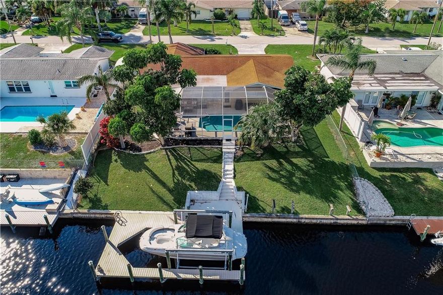 Attn: All Boaters direct access to the river in minutes! Nice Boat dock & Lift. Well maintained 3/2/1 Gulf Access Home. Screened in lanai with a pool nice deck area and great waterfront view. Enjoy all the outdoor living in Southwest Florida! Relax on the dock where you fish or enjoy the sunshine! Split floor plan design with a living room and den. Galley kitchen, tile flooring this is the perfect vacation or forever home. City utilities Paid. PLEASE NOTE THAT THERE IS A STEP DOWN FROM THE LIVINGROOM.