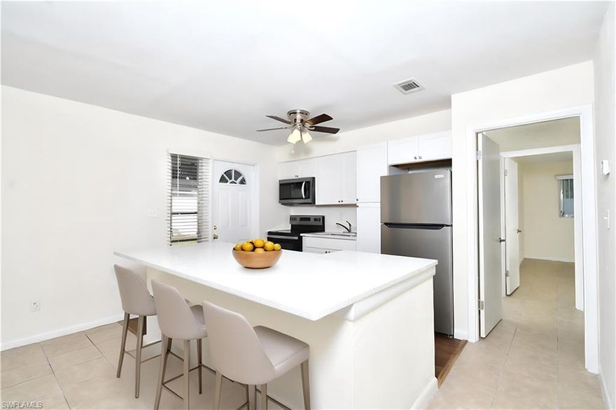 JUST REDUCED!!! ALL BRAND NEW AND READY TO BECOME YOUR NEW HOME. BEAUTIFUL OPEN FLOOR PLAN, NICE LIVING RM, DINNING AREA ALL
 OPENED TO YOU ALL NEW KITCHEN WITH WONDERFUL WHITE SHAKER CABINETS, ISLAND FOR BAR STOOLS, QUARTZ COUNTERTOPS, ALL NEW STAINLESS APPLIANCES, Located in a 55+ community Orange Grove Park. Stunning 2BD/2BA. New wood plank flooring and tiled throughout the rest. All newly painted throughout, updated two full baths, nice brand new stackable washer/dryer included, new ceiling fans in all rooms, walk-in closet and lots of windows with new treatments to let that Florida sunshine in. The private paved patio is accessed from the kitchen exterior door and the community has a lovely private park-like setting with shuffleboard and seating areas right across the street. Beautiful flowering shrubs, and freshly updated beds. **Lawn Care and Trash Included. Service Animals allowed. Please call for your personal showing Appt. DISCLOUSURE: PHOTOS HAVE BEEN ENHANCED WITH FURNISHINGS VIA AI STAGING