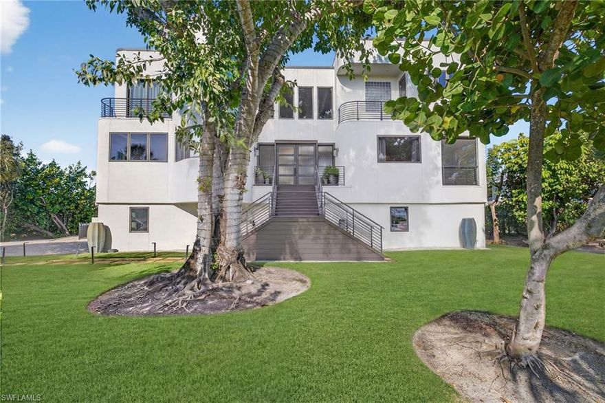 Located along the highly desirable West Gulf Drive corridor, this tri-level, 4 bedroom, 3.5 bath home offers an exceptional opportunity to enjoy refined island living on over half an acre of land directly across the street from the beach. This spectacular property spans 3,994 sq feet and showcases a striking contemporary design with distinctive art deco lines, defined by massive geometric forms, curving expanses of glass block, rounded corners, and an impressive six balconies and decks—creating a home that is both architecturally bold and uniquely coastal. The thoughtfully designed floor plan features expansive, light-filled interiors and open living spaces ideal for entertaining or everyday comfort. At the heart of the home, a gourmet kitchen anchors the main living area, offering a functional yet elegant space for hosting, and daily living. All impact windows and doors provide peace of mind, enhanced storm protection, and energy efficiency, while modern finishes and architectural details elevate the home’s sophisticated yet welcoming feel. The tri-level layout allows for excellent separation of space, with generous bedroom accommodations offering privacy and flexibility for family and guests. Outdoor living is a true highlight, featuring a screened lanai porch overlooking a private pool and spa. Adding exceptional functionality, the property includes a 3-car garage along with a large lower-level storage area, ideal for bikes, kayaks, beach gear, and island essentials. Deeded beach access places Sanibel’s white-sand shoreline just moments away, while the across-the-street beach location allows for effortless days of shelling, sunset walks, and coastal living. Set in one of Sanibel’s most sought-after locations, this residence offers convenient access to scenic bike paths, renowned dining, and the island’s natural beauty, all while maintaining a tranquil and private setting.