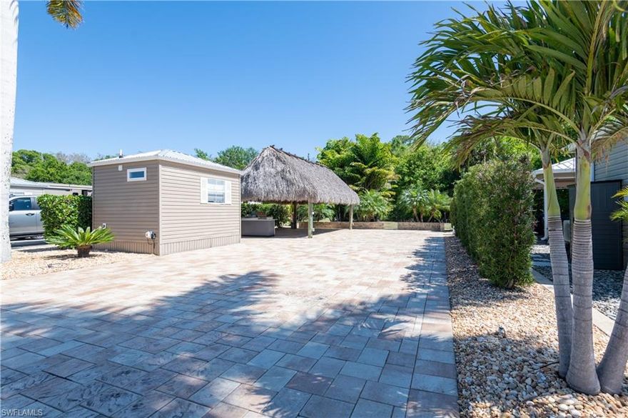 Lot 122  features a fully extended 45 x 90 paver lot designed for comfortable outdoor living and entertaining. The property includes a spacious 14' x 24' tiki hut providing ample shaded space for gathering and relaxation. Under the tiki is a well-appointed outdoor kitchen complete with built-in BBQ grill, refrigerator, sink, and NewAge outdoor cabinets for additional storage and prep space. A mounted TV makes the space ideal for entertaining, and a Thermacell Patio Shield insect repellent system adds additional comfort for outdoor enjoyment.

The lot is finished with extended pavers and a pavestone retaining wall, creating a clean and functional outdoor layout.

The finished shed offers additional living and utility space and includes a new mini-split A/C system, LG washer and dryer, refrigerator, built-in desk/work area, and bathroom.

This well-appointed lot combines functional upgrades with inviting outdoor living space, making it ideal for enjoying the resort-style lifestyle at Cypress Trail RV Resort.