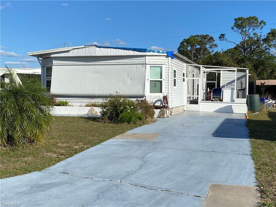Nice Double-Wide Manufactured Home with three bedrooms/2 bath.   Hurricane Damage to Carport, Florida Room and Utility Room.  New windows 2022.  Re-piped 2017.  Refrigerator/Freezer and Dishwasher 2017.  Extra Refrigerator/Freezer in Utility Shed 2017.  AC 2014.  OWN YOUR LAND in this 55+ active, pet friendly community. Maintenance Fee is only $77/month.  Carriage Village has a large heated pool, clubhouse, hobby shop, library, billiards room, shuffleboard, bocce ball, ceramics, putting green, dances and so much more.  Enjoy the FLORIDA LIFESTYLE!