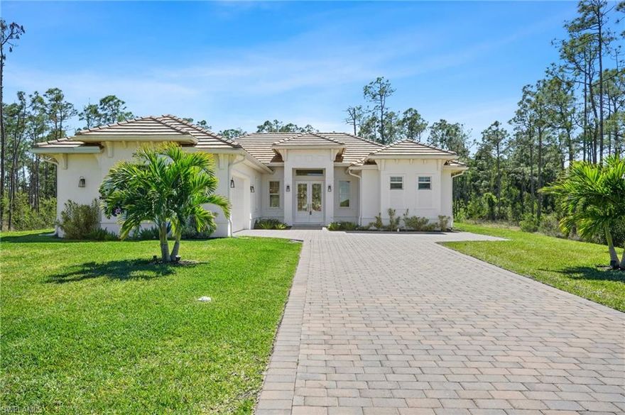Welcome to 25340 Divot Drive, a custom-built 4-bedroom, 3-bathroom home nestled in the intimate Trieste Preserve community of Bonita Springs. Constructed in 2022, this residence offers 1,906 square feet of thoughtfully designed living space on an expansive 0.91-acre lot, providing ample room for outdoor activities and privacy. 
Key features include:  Modern Construction: Built with quality materials, featuring a durable tile roof and impact-resistant doors and windows for enhanced safety and longevity.  Elegant Interiors: The home boasts 8-foot doors throughout, wood-cased windows, and an open floor plan that seamlessly connects the living, dining, and kitchen areas, creating an inviting atmosphere for both daily living and entertaining.  Gourmet Kitchen: Equipped with modern appliances, ample cabinetry, and a spacious island, the kitchen is a chef's delight, perfect for preparing meals and hosting gatherings.  Outdoor Living: The expansive lot offers endless possibilities for outdoor enhancements, whether it's creating a lush garden oasis or installing a custom pool.  Community Charm: Trieste Preserve is a quaint enclave limited to only 14 single-family homes, ensuring a tight-knit community feel. Its proximity to downtown Bonita Springs means you're just minutes away from shopping, dining, and beautiful Gulf beaches.   Additional amenities include a brick paver driveway, an epoxied garage floor, and a serene wooded area view, enhancing the property's appeal. This home represents a unique opportunity to own a piece of Florida paradise, blending modern comforts with the tranquility of a private, spacious lot.