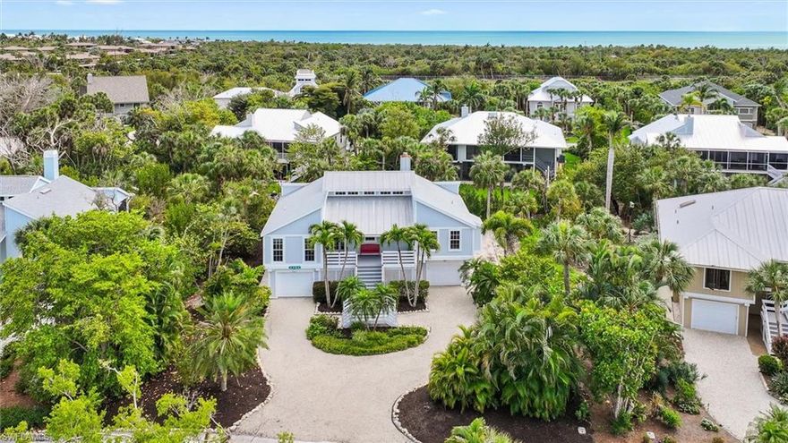 Southern charm meets relaxed Key West style in this Sanibel Bayous retreat, ideally positioned on a quiet cul-de-sac just a stone’s throw from the sugar-white sands of Bowman’s Beach. Whether envisioned as a forever home, seasonal escape, or investment opportunity, this residence offers an effortless island lifestyle, perfectly placed to enjoy the very best of Sanibel. Framed by lush tropical landscaping and a welcoming front porch, the home opens to a light-filled interior with soaring volume ceilings. The great room is both inviting and grounded, anchored by a striking stone-mantled, wood-burning fireplace. A wall of glass sliders and French doors—offering two points of entry—opens to the screened rear lanai, where gentle tradewinds drift through and indoor-outdoor living feels effortless. Both the primary suite and a guest bedroom offer direct access to this peaceful outdoor setting. The spacious kitchen is appointed with stainless steel appliances and ample cabinetry and counter space designed to flow seamlessly into the main living and dining areas. Generously sized bedrooms and updated baths provide comfort and flexibility, while thoughtful features like a metal roof, dual porches, and dedicated storage for bikes and beach gear enhance everyday ease. Offered furnished, the home is move-in ready—allowing for an easy transition to island living from day one. Located in the sought-after Sanibel Bayous community, residents enjoy access to a community pool, clubroom, and tennis/pickleball courts—all just moments from one of Sanibel’s most beloved beach accesses. A true island escape—unassuming, inviting, and perfectly placed to enjoy the best of Sanibel.