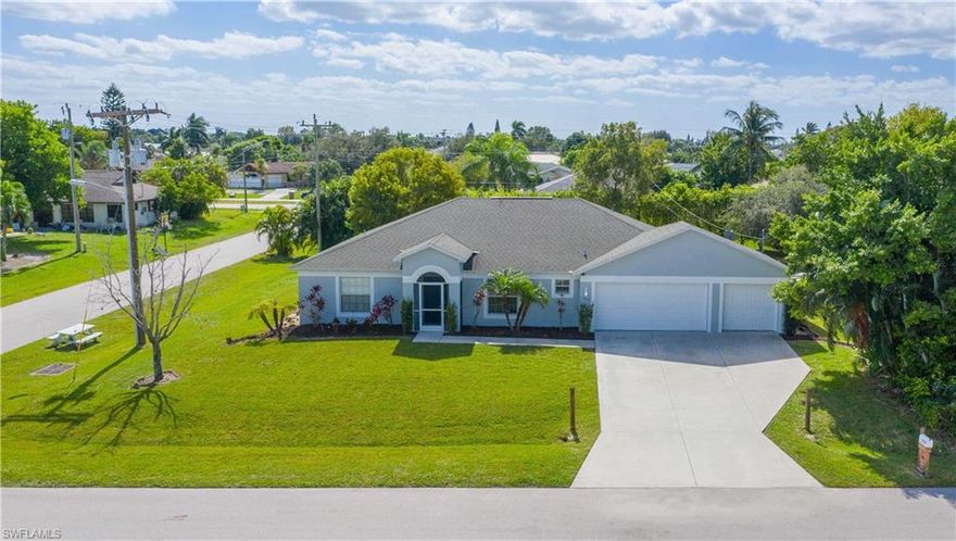 Wow...Wow...Wow....You have to see this sprawling 4 bedroom, 2 bathroom 3 car garage home located in a very desirable area of SE Cape Coral on a hard to come by TRIPLE CORNER LOT.  This home boasts an open floor plan w/ gourmet kitchen, a massive pantry & large island/breakfast bar overlooking a huge living room.  This space is perfect for entertaining friends or a large family.  The home offers many upgrades that include wood cabinetry, granite countertops, 5 1/4 baseboards, as well as tile floors throughout the entire living area of the home w/ brand new carpet in the 3 of the bedrooms.  Other upgrades include newer a/c unit, as well as new paint on the interior & exterior.  The master suite encompasses an extra large bedroom w/ huge walk in closet & the bathroom has separate garden tub/shower.  The exterior of the home offers a large screened patio w/ an additional concrete slab that runs almost the entire length of the home, making for the perfect opportunity to build your dream outdoor living oasis.  Enjoy the lush landscaping and Ohhh Wait...a huge 3 lot site that give you space between your neighbors & lots of opportunity for storage/boats, etc.  This home is a must see.