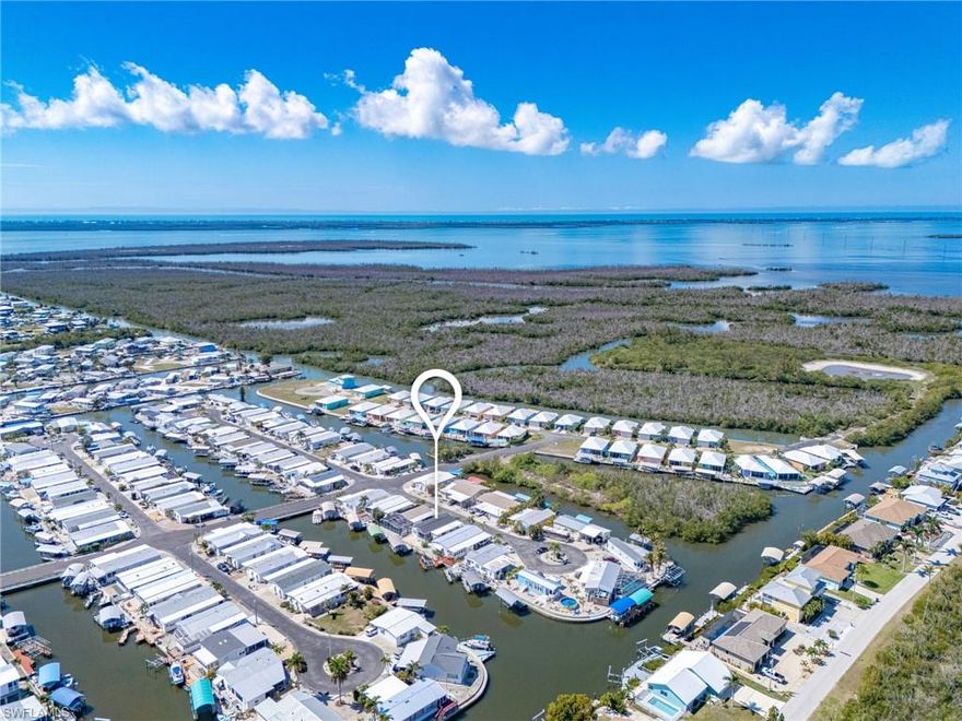 Welcome home to this charming Pine Island community of St. James City! This NEWER 2018 DIRECT ACCESS home is being sold FURNISHED with beautiful coastal décor and offers Gulf access along with breathtaking water views. Boating enthusiasts will appreciate the dock featuring a new 7,000 lb boat lift with canopy, an additional lift for kayaks, and a convenient fish cleaning station—perfect for enjoying the island lifestyle. Recent upgrades include a new HVAC system, water heater, upgraded kitchen appliances, impact windows, a newer dimensional roof, and upgraded spray foam insulation installed underneath the home in 2023 for added efficiency and durability. A carport and screened lanai provide additional comfort and functionality for outdoor living and entertaining. The home sits at a nice HIGH ELEVATION, offering added peace of mind. Just bring your toothbrush and move right in to start enjoying the relaxed waterfront lifestyle that makes St. James City so special.