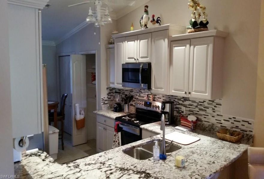 Barington Beauty - $48,000 in upgrades, PLUS all the furniture. This outstanding condo home includes, front and rear acrylic slider lanai enclosures, additionally, both lanais feature electric hurricane shutters, are carpeted and nicely furnished. The front entry door also has an electric hurricane shutter. The kitchen was completely remodeled 3 year ago by adding grade 4 granite and top of the line appliances, the bathroom(s) were remodeled 1 year ago adding granite counter tops, sinks, faucets, and lighting. The master bathroom had all new cabinetry, granite counter tops, sinks, faucets, lighting, ceiling fan, and features a walk in shower, recently painted. The living room features,Thomasville furniture wood cabinetry and tables, with an electric recliner leather couch, Smart HDTV's 47 and 32" in the master bedroom. Leaving Waterford crystal glassware, new pots/pans and silverware, the dining room features a custom round table that expands 
to stay round and seat 8 comfortably. The dining room light fixture is a hand blown and signed glass beauty - a matching entry hall fixture. 12 ft ceilings. AC 5 years old with a new compressor , HW is 3 years old.