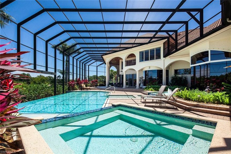 This distinctive home is a masterpiece. Interior detailing with marble floors warmed with wood finishes, coffered, Pecky Cypress planked ceilings, architectural nuances, and attention to detail make this home a stand out. The gourmet kitchen offers both electric and gas cooking options and eat-in dining. Sliding glass walls disappear, ushering in alfresco living, complete with a stunning stone fireplace, outdoor kitchen, multiple seating and sunning areas. The infinity-edge pool has been resurfaced and re-tiled, new pump and heater, new pool screen, fresh landscaping, new lighting, conversion to saltwater, and an added saltwater spa. Master suite includes a windowed sitting area, private access to the pool and deck, a morning kitchen, dual vanities, custom closets, a spa tub, and a spacious walk-in shower. Upper floor guest suites and loft capture vista views from expansive windows and private balconies. Separate guest cabana and bath. Smart Home features full exterior cameras that allow for remote communication from around the world. Air-conditioned garage with hydraulic car lift, ample storage, and garage doors to current code.