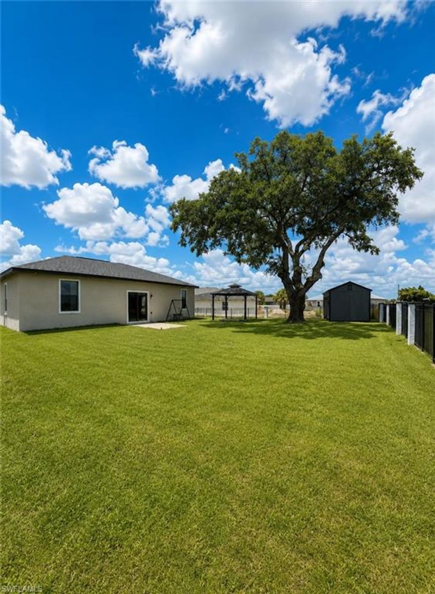 Welcome to 1224 Jupiter Loop, a beautiful property offering the perfect blend of privacy, outdoor enjoyment, and functional upgrades. Sitting on an oversized lot, this home is framed by a gorgeous mature tree that provides natural shade and creates a peaceful, park-like setting right in your own yard.

Inside, you’ll find a well-designed 3-bedroom, 2-bathroom layout featuring vaulted ceilings and upgraded closets that maximize storage and organization throughout the home. A security system is included for added peace of mind, along with a dedicated laundry room equipped with a washer and dryer for everyday convenience.

Step outside and you’ll immediately appreciate the custom fencing that surrounds the property, offering security, style, and plenty of room to enjoy. The expansive greenbelt behind the home not only enhances your privacy but also provides direct access from the rear of the property via Cowgirl Way—a rare and valuable feature for added convenience.

This property is truly designed for outdoor living. It includes a spacious storage building, perfect for tools, equipment, or hobby space, along with a beautiful gazebo ideal for relaxing, entertaining, or enjoying Florida’s stunning sunsets.
Whether you're looking for extra space, privacy, or a property with unique outdoor features, this home delivers it all.