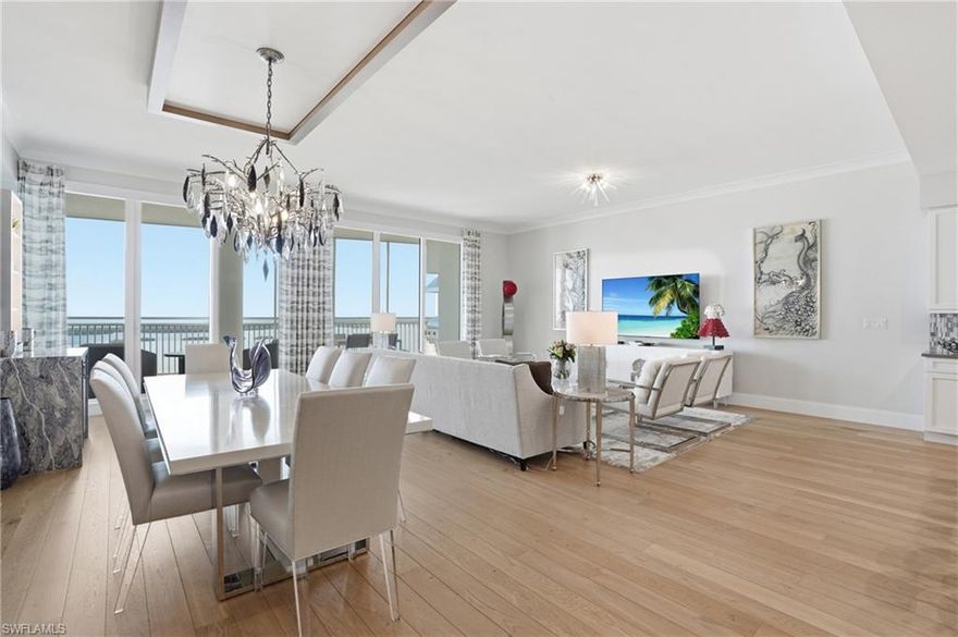 Step into this stunning 20th-floor, fully furnished residence in the prestigious Seaglass high-rise of Bonita Bay. You will be immediately captivated by breathtaking western views, which create a striking first impression. This beautifully designed three bedroom plus den, four bath home features an open-concept living, kitchen, and dining area, seamlessly blending elegance and comfort. The great room is enhanced by volume ceilings, lovely furnishings, custom lighting and rich wood flooring.  A private elevator lobby welcomes you into a thoughtfully curated space designed for both everyday living and upscale entertaining. The gourmet kitchen showcases a large island with abundant drawer storage, a gas oven, premium appliances, and a gorgeous custom backsplash. Entertaining is effortless with a free standing ice maker and two well-appointed bar areas in the dining space, each featuring its own wine cooler.. Experience true indoor/outdoor living all winter long with sliding glass doors that open to the lanai.  Here, you will also find a gas grill, plenty of dining and lounging space and the perfect space to enjoy evening sunsets. The expansive primary suite, off the great room, is a true retreat, offering access to the western lanai and sweeping Gulf and Bay views, along with a highly upgraded spa-like ensuite bathroom. Ideally positioned away from the guest suites, the primary suite provides ultimate privacy. Two guest ensuites are located on the east side of the residence, each with its own balcony access, creating a welcoming and private experience for visitors. Offered furnished and move-in ready, this residence embodies refined coastal luxury. Seaglass amenities include a luxurious lobby, a fitness center, a theatre, a stunning resort style pool & more! Spend the day at the Beach Club, playing tennis or golf, or just lounging at the pool. With a year-round sea breeze, you will never want to "head north" again! The perfect home, located in the perfect community. Bonita Bay offers an array of exceptional amenities, including a private beach club, kayaking, canoeing, pickleball, tennis, and multiple community parks. Explore over 12 miles of walking and biking paths, or take advantage of the full-service marina and restaurant. Golf enthusiasts will appreciate the FIVE on-site courses, several dining options, a state-of-the-art fitness center, and more--all available with club membership (additional fees apply). Located just a short drive from world-class dining, shopping, beaches, and nature preserves, you'll also enjoy easy access to the burgeoning downtown Bonita Springs and downtown Naples. RSW International Airport is conveniently nearby!