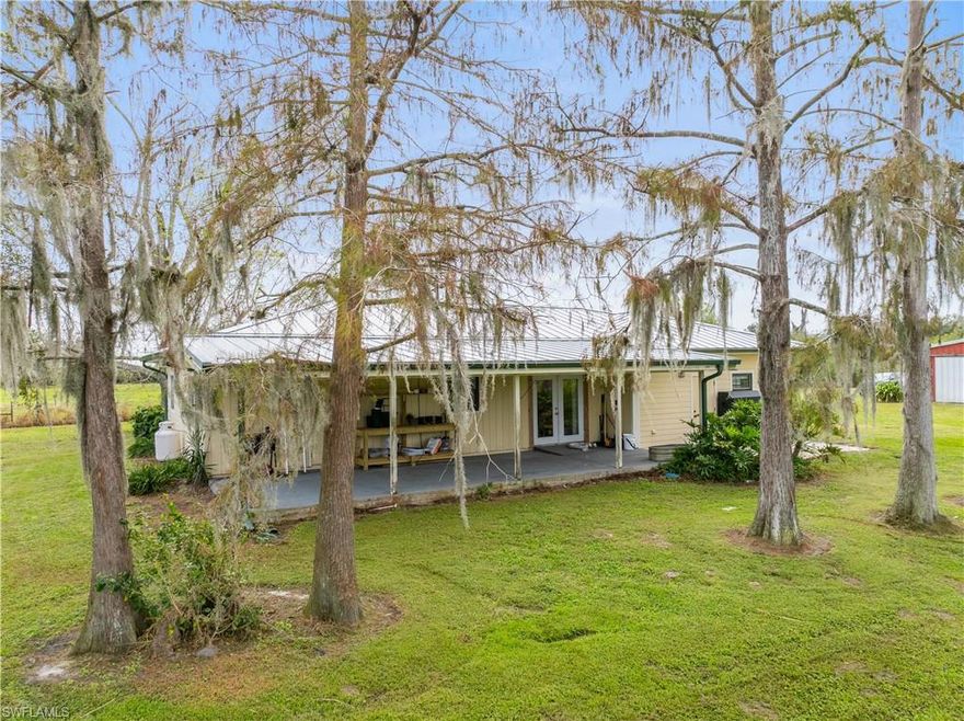 Awesome property fully fenced and NO FLOOD REQUIRED! Four-bedroom, two-bath home with a 49’ x 58’ barn/workshop located on a 14-acre secluded parcel. The home features an open floor plan, with a bay window in the living room and French doors in the dining room providing plenty of natural light. The kitchen’s high end appliances are less than three years old, and cooking on a six-burner gas stove is a dream. The kitchen is wired for an electric range if you prefer. A large island gives plenty of room for two chefs in the kitchen. The split floor plan allows privacy in the master bedroom suite. A bonus room, currently used for an office, could be a fourth bedroom. The inside laundry room is tucked away in the bonus room. An open lanai spans the entire back of the home, providing a great place for morning coffee, spending lazy afternoons in the shade of towering bald cypress trees covered in romantic Spanish moss, or watching the multitude of birds over the pond. Solar panels on the metal roof will assure you lower electricity bills, less than $100.00 monthly with a refund from FPL at year end for electricity sent to their grid. Electric panel is wired for a generstor. An eighteen-inch well with a pump and PTO is located at the rear of the property. Add a sixty HP power unit or tractor and you’re in business. Wanting a dream workshop? Check out the fully wired shop set up for those important projects. Seven acres at the front of the property provide privacy from Highway 31, and seven acres to the rear of the property contain a one-acre stocked pond and numerous orange and tangerine trees. Looking for a mini farm? Check out the chicken house and fully fenced cleared pasture for horses or cows. Call today for your private tour.