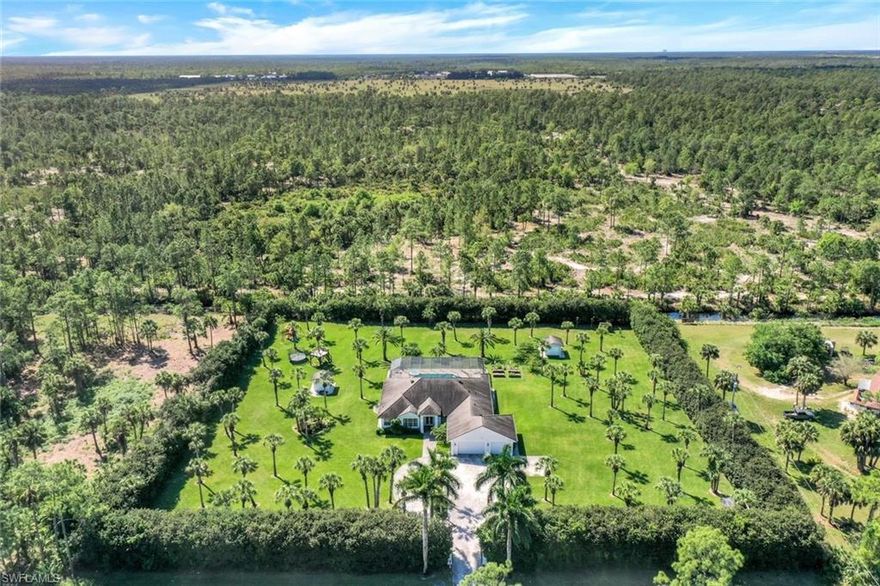 Welcome to your private sanctuary, a stunning 3000 sq ft residence nestled on 3 acres of meticulously landscaped and irrigated land. This fully fenced gated property offers an unparalleled blend of lifestyle convenience and tranquility. The homes open floor plan features large windows that flood the space with natural light highlighting the spacious layout. The Chefs kitchen with double oven, cook top and plenty of counter space and cabinet storage .. 3 well appointed bedrooms and 3 full bathrooms plus a dedicated pool bath off the lanai. Take a dip into the sparkling pool or unwind in the hot tub all while enjoying the Florida Sun. The 3 acres are a gardeners paradise with a variety of trees from various palm trees to Banana, Mango, lemon, avocado, Jamaican cherry and more! This estate is a rare find, offering both the peace of country living and convenience of easy access to shopping & dining.