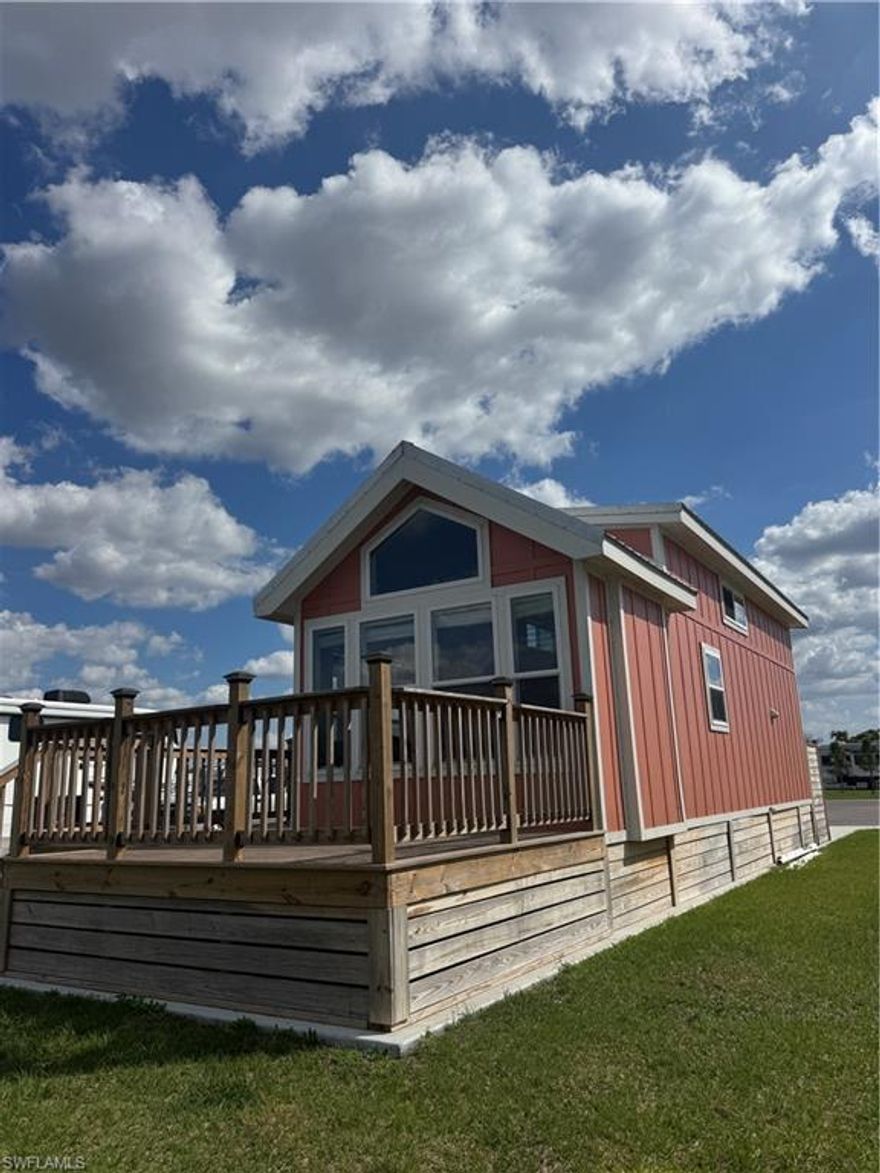 Lakefront Park Model Retreat | Palm Breeze RV Resort – Charming Punta Gorda, FL

Welcome to the Park Model Collection at Palm Breeze RV Resort, located in charming Punta Gorda, FL. This beautifully designed coastal-style park model with loft offers approximately 399 sq ft of living space plus a spacious sleeping loft, providing comfortable room for family and guests.

The open-concept living area features vaulted ceilings, large windows, and abundant natural light. The kitchen includes full-size appliances, generous cabinetry, and a functional layout ideal for seasonal living or extended stays. The private bedroom offers a cozy retreat, while the loft provides flexible space for guests or storage.

Enjoy the covered front porch and expansive deck overlooking the lake, perfect for relaxing or entertaining.

Lot 235 is a rare lakefront cul-de-sac site offering privacy and minimal traffic. The spacious 4,970 sq ft lot includes a 20' x 70' concrete RV pad, providing plenty of room to enjoy the Southwest Florida lifestyle.

Palm Breeze is a pet-friendly, rental-permitted luxury RV resort featuring a Tiki Bar, resort-style pool and spa, clubhouse, pickle-ball courts, fitness center, dog park, children’s playscape, activities director, and on-site café, with a resort store coming soon.

Conveniently located near Punta Gorda Airport, I-75, shopping, dining, Charlotte Harbor, and Gulf beaches including Englewood Beach, Boca Grande, and Fort Myers Beach.