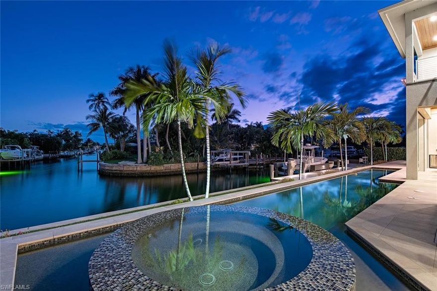 Like new, coastal contemporary home in sought-after Royal Harbor. Discover luxurious living at this custom residence complete with Lutron
lighting system, security cameras, oversized three-car garage, resort-style pool/spa, gas fireplace and climate-controlled wine room! The true chef’s kitchen features top-of-the-line appliances including Thermador 48” range with oven, steam oven and warming drawer, Thermador counter depth refrigerator/freezer and two large islands with plentiful storage. Entertaining is a breeze with expansive outdoor living which encompasses a full kitchen with a gas grill, dining area, living area and infinity-edge pool and spa. Home is finished with a custom dock with seating area, 13,000 lb boat lift, plus 15’ x 15’ elevator lift for jet skis and kayaks. Conveniently located just a short distance from 3rd Street South and 5th Avenue South’s fine dining, world-class shopping and white sand beaches.