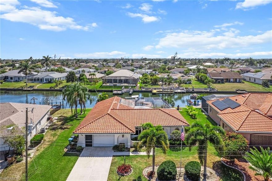 Welcome to this beautifully modernized Gulf-access pool home in SE Cape Coral. This inviting residence features 3 bedrooms and 3 full bathrooms, including a convenient pool bath, and is being offered turnkey for an easy move-in experience. Recent updates include a brand-new hot water heater (2026), a fully renovated pool bath with new plumbing, and new tile flooring throughout the home. The desirable south rear exposure provides all-day sunshine over the pool, which is equipped with a solar heater for year-round enjoyment.

Relax beneath the covered lanai while taking in stunning views of the more than 100-foot-wide canal and basin. Boating enthusiasts will appreciate the wrap-around composite dock with a 10,000-lb aluminum boat lift, providing quick access to the Gulf. Additional highlights include a new tile roof (2025), all assessments paid, and no history of flooding. Schedule your private showing today and experience waterfront Florida living at its finest!