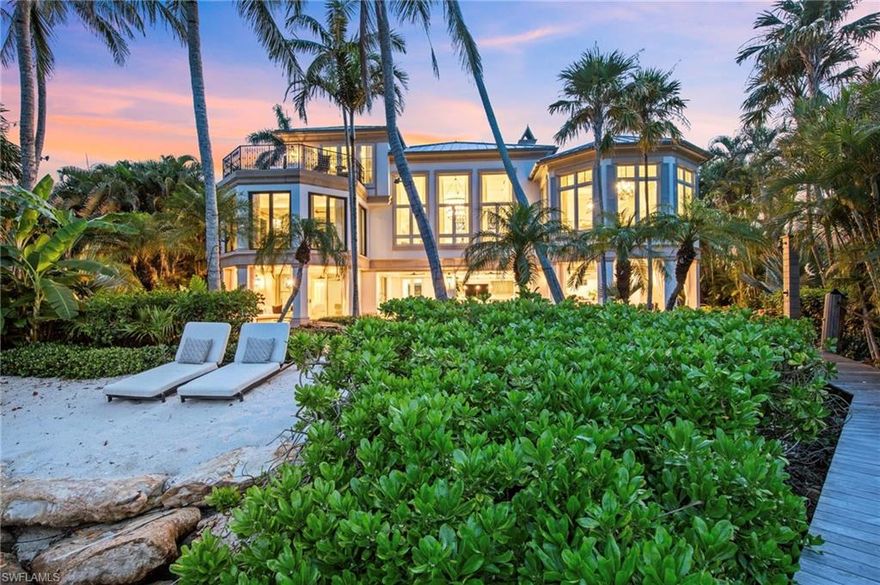 IMMEDIATE RESIDENT FULL PORT ROYAL MEMBERSHIP! Perched against the stunning backdrop of Champney Bay, this exquisite property, inspired by the aesthetics of the French West Indies, has been thoughtfully designed by the acclaimed architect Jeff Harrell. After an extensive two-year whole home renovation completed in 2022, the estate underwent a comprehensive outdoor and lower-level renovation in 2024, executed by the esteemed Knauf-Koenig Group. This remarkable multi-structure Port Royal residence boasts five bedrooms, a den, and 6.5 bathrooms, masterfully fusing timeless elegance with modern luxuries. Upon entering this captivating home, you are immediately surrounded by an array of ultra high-end finishes and contemporary details, creating an ambiance of refined sophistication throughout. The gourmet kitchen is a culinary dream, featuring premium Officine Gullo and Gaggenau appliances. The stunning primary suite, which occupies an entire level, serves as a personal retreat. It offers a private waterfront balcony, expansive mahogany walk-in closets, a convenient morning kitchen, and a lavish bathroom adorned with an exquisite mother-of-pearl domed ceiling, cultivating a serene yet luxurious atmosphere. The outdoor areas are reminiscent of a high-end resort, showcasing a magnificent pool, a peaceful koi pond, and a remarkable double-sided marble fireplace that enhances the natural beauty of the surroundings. The thoughtfully designed outdoor kitchen, private sandy beach cove in addition to private beach access off Gordon Dr, and various terraces provide an ideal setting for seamless entertaining amid lush tropical landscaping. Additionally, this home features private beach access and a dock located just a short distance from Gordon Pass allowing for direct access to the gulf, making it perfect for boating enthusiasts. For car aficionados, the estate features three garages with the capacity to accommodate up to nine vehicles or 13 vehicles with lifts. Residents enjoy exclusive membership eligibility to the prestigious Port Royal Club, adding yet another enticing aspect to this extraordinary property.