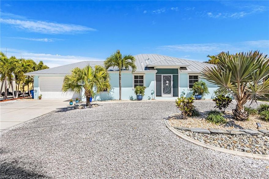 Bright and cheerful throughout, this furnished waterfront home in Pine Island’s Manatee Bay offers spacious, open living areas designed for comfortable coastal living. The kitchen features a large breakfast bar and beautiful coastal décor.

The generous outdoor space offers a heated pool, and spa—perfect for enjoying the island lifestyle. A versatile bonus room adds flexibility for a home office, guest space, or hobby area. The well-appointed laundry room offers plenty of storage, and the two-car garage provides additional convenience.

Built with a durable metal roof and surrounded by carefree island landscaping, this home is designed for easy living. Across the street, a dedicated green space offers ideal boat trailer storage. Just added Flood Gates for peace of mind!!

At the water’s edge, a wrap-around dock with a covered boat lift sits on a deep-water canal, providing quick access to Matlacha Pass and some of the area’s best boating, fishing, and island-hopping. Enjoy nearby destinations like Cabbage Key for a “Cheeseburger in Paradise” or the pristine beaches of Cayo Costa and Picnic Island—all just a short boat ride away. Note: The voluntary HOA provides access to the community boat ramp.