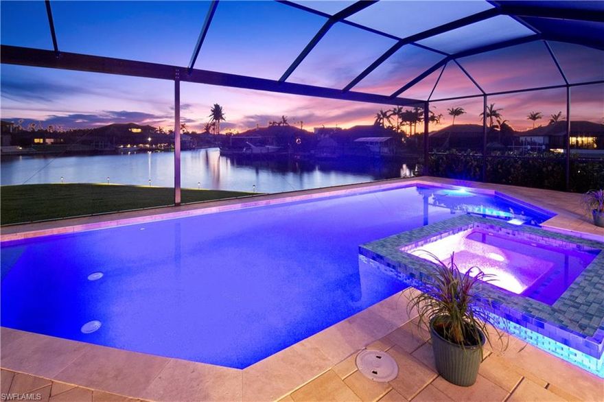 Step into the epitome of luxury with this stunning, newly 2023 built gulf access waterfront residence.  4 opulent bedrooms, 3.5 lavish baths, and a spacious 3 car garage, this home is a masterpiece of design and craftsmanship. As you step in, you'll discover not just a home, but a statement of grandeur and leisure, set against a backdrop of awe-inspiring water views. A grand foyer that leads into a voluminous layout made for entertaining and generously sized great room graced by a fireplace and large sliding doors for views of the water. Host the most fascinating events in the elegant formal dining room including a butler’s area and wet bar, where you can host magnificent dinner parties. An awe-inspiring chef's kitchen with top-of-the-line KitchenAid appliances, 6 slabs of quartz counter tops, a center island perfect for meal prepping, and custom cabinetry including combined 60” of upper cabinets with sand blasted glass featuring lighting for an extra touch of elegance. Just off your kitchen, open your family room’s sliding doors to create the most magnificent indoor/outdoor living area and enjoy the evening with al fresco dining. This home was built with full entertainment and relaxation in mind. A divine master suite presents tray ceilings, massive windows with sliding door to your lanai overlooking the water, his and hers (11’x11’) closets and a spa-style ensuite bath with a soaking tub, separate glass steam shower and individual his & her vanities areas. Guest bedrooms featuring ensuite luxury bathrooms with 1 accessible pool bath. Live the most perfect SWFL dream outside with multiple outdoor seating areas including an under-truss entertainment space for year-round outdoor enjoyment. An exquisite, deep (6’ at end) large pool with sun shelf and water feature and 6-person spa overlooking the intersecting waterways. The summer kitchen includes a backsplash and countertop made of gorgeous sea glass that will definitely be a focal point of discussion. 240 feet of prime seawall frontage on breathtaking intersecting canals allows you to choose the perfect spot for your boat dock for unobstructed views. Take advantage of this rare opportunity to live in your own slice of paradise and schedule your private showing today.