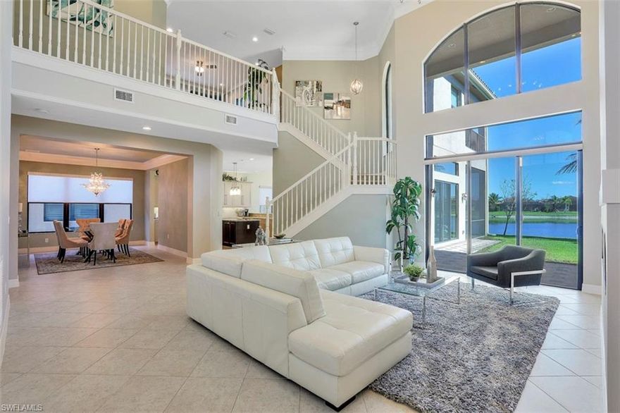 MODEL QUALITY! This immaculate "Dubonnet Grande" is located in one North Naples hottest communities, Riverstone. This impressive residence offers almost 5000 Sq Ft under air, 4 Bedrooms, Den, Loft, Game Room, 5.5 Baths, 3 covered lanais, and has room for the whole family! You will be impressed the moment you walk in the door to 20' ceilings, floor to ceiling windows, built in LED fireplace, electric roll down solar shades, custom wall finishes, rich moldings, and more! Other fine appointments include HURRICANE IMPACT WINDOWS & DOOR THROUGHOUT, diagonal tile, bath tile to the ceiling, pre-plumb for outdoor kitchen, pool pre wire, custom laundry room with extra cabinets, custom paint, and more! Room to build your dream pool/spa/lanai to fit your lifestyle! Riverstone offers new modern living along with an amazing clubhouse, which features a Resort Style Pool, Lap Pool, Hot Tub, Kiddie Water Park, Outdoor Party Pavilion, Tennis Courts, Tot Lot, A/C Indoor Sports Court, Soccer Field, Social Rooms, Billiards Room, Dance Studio, & more! Riverstone is conveniently located just 2 min from I75, 15 min to the Beach, and 20 min to 5th Ave/Coconut Point/RSW Airport.