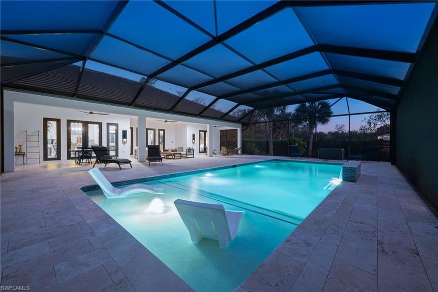 Luxurious, sophisticated family compound including a MAIN HOUSE (2,657 Sq. Ft.) plus separate GUEST HOUSE (800 Sq. Ft.) = 3,457 total Sq. Ft. of living space under A/C on 2.6 private acres just off Wilson Blvd. corridor in highly desirable Golden Gate Estates.  This multi-generational property offers space, privacy and natural beauty, highlighted by organic food forest throughout the grounds.  The main residence features 3 ensuite bedrooms with full baths and bidet toilets, plus flexible space for additional primary suite or in-law configurations.  The den/study also includes it's own bathroom and private exterior entrance.  Soaring ceilings and oversized impact windows and doors enhance both security and natural light.   Enjoy the custom oversized natural heated pool with over 2000 sq. ft of lanai space, designed with an advanced natural filtration system and no chlorine required.  Ideal for entertaining, family gatherings and making memories.  The chef's kitchen features granite counters with full backsplash, 42'' soft-close cabinetry, a very large waterfall island with plenty of storage, KitchenAid stainless steel appliances and an induction cooktop.  An oversized undermount stainless steel sink with spray faucet and generous prep space completes the design.  The open living area includes a feature wall and double fireplace shared with the dining area.  The primary bath offers a large walk-through multi-head shower, a soaking tub, granite countertops with dual sinks and custom his and hers closet systems.  Plank tile flooring runs throughout the house for style and durability.   A separate 800 sq. ft. guest house includes 2 bedrooms and a full bath with bidet toilet, providing excellent guest or extended-family accommodations.   The property is fully fenced with two electronic entry gates for added privacy and security.  The grounds are fully irrigated and include 89+ organic fruit trees and extensive raised garden beds with herbs, greens and tropical plantings.  Additional features include RV parking with charging station, separate septic systems, separate electric meters for main as well as guest house and ample parking space for additional vehicles, ATV's boats etc.  The sellers have invested an additional $1 million dollars in enhancements and upgrades, creating this incredible dream home complex that is conveniently located near schools, shopping, dining, Audubon Corkscrew Swamp Sanctuary, Rookery Bay, Collier boat ramps and the recently completed 150 acre Big Corkscrew Island Regional Park with aquatic center, sports fields, courts and community amenities, including day care.  A rare Naples estate offering versatility, privacy, space and definitely resort-style living!