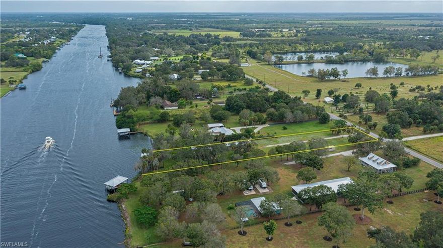 This one-of-a-kind old Florida home is situated along the banks of the beautiful Caloosahatchee River and features a boat dock with deck and lift, storage shed and a 5-car garage all on approx. 1.3 pristine acres. The comfortable home is uniquely built of milled cedar, which offers self-preservative characteristics and is insect resistant. It also boasts an impressive two story screened enclosure overlooking the expansive intracoastal waterway (providing access to both coasts) as well as two separate living areas. The main 2 bedroom/2 bath residence encompass the second and third floors while the ground level features a studio apartment with kitchen, bath and a screened lanai. The home can be utilized any number of ways. Rent one or both units and keep in mind the home is also suited for multi-generational occupancy or ideal for a home based business. The main home nests in the midst of spectacular old oaks and provides the perfect setting for just kicking back and relaxing on one of the many decks while enjoying the best life has to offer on the river. BONUS: all structures have sturdy galvalume roofs. Call today for your private showing.