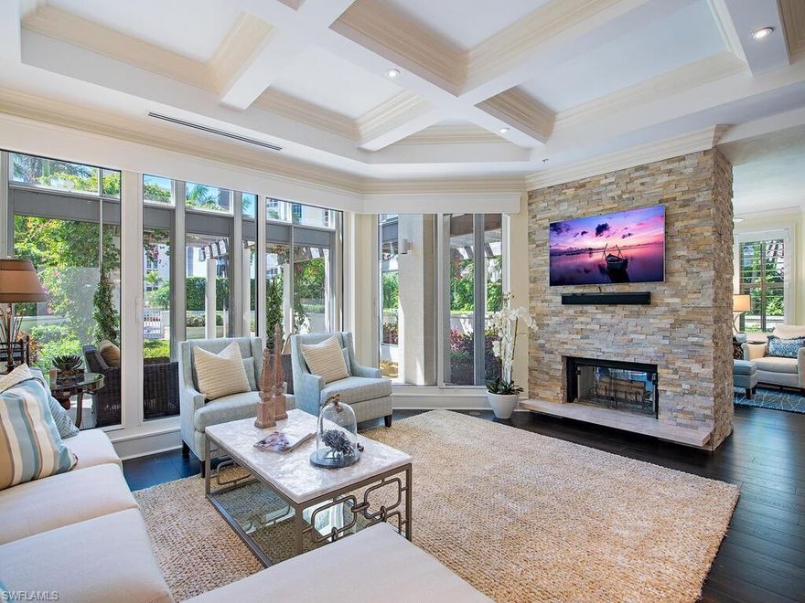 Live luxuriously in this exquisitely renovated Villa designed by Jon Kukk and remodeled by Hartwick. Boasting a grand 35-foot entrance, private elevator, gourmet kitchen with Ruffino custom cabinetry, dual side stone fireplace, and two-car garage it truly lives like a single family home. Featuring a stunning open floor plan living space, perfect for entertaining with impressive kitchen island that opens to an expansive private 2-story garden view patio.  The spacious master bedroom en-suite features a sizeable master bath with French tub and walk-in shower, dual custom closets, and a private terrace to enjoy gorgeous sunsets. The Brittany is one of the flagship buildings in Park Shore offering residents a well-equipped fitness room, a card room, private beach access, two guest suites, tennis courts, a resort-style, beachfront pool and spa area and 24-hour security. Steps to Venetian Village & central to all that Naples has to offer from the charming downtown districts of 5th Ave S & 3rd St, to Waterside Shops, Artis-Naples & Mercato for upscale dining, shopping & entertainment. Owners in The Brittany Villas can also lease or purchase a boat slip in the Venetian Yacht Club.