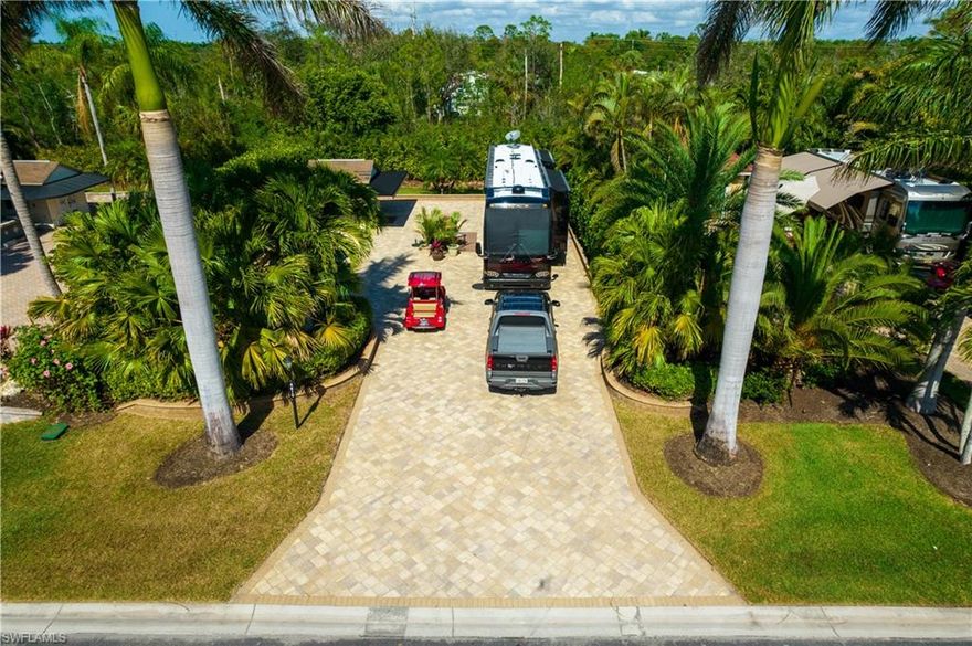 Large off lake site located in Pelican Lake Motorcoach Resort.  This is a move-in ready fully upgraded site with a paverblock pad and patio and raised wall edging.  Very large outdoor living area with the utmost privacy from the tropical landscaping.  The 10x10 coachhouse is built out and finished with washer & dryer, sink, toilet, convection microwave. and counter top.  Area for a desk or couch.  The outside is finished with a large wrap around awning.