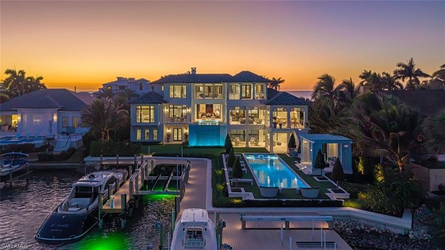 A rare and inspiring waterfront offering on Gordon Drive, showcasing wide, sweeping vistas across Champney Bay. Impeccably designed by Stofft Cooney Architects and built to exacting standards in 2023 by the highly acclaimed Williams Group, this exceptional residence delivers an unparalleled combination of scale, craftsmanship, and setting. The home features six bedrooms, eight baths, and more than 9,000 square feet of air-conditioned living space, complemented by an extraordinary amount of garage capacity accommodating up to eight vehicles, 120 feet of water frontage, and approximately 185 feet of shoreline. The main living level sits at 18’ FEMA elevation, creating a distinctive blend of expansive water views, enhanced privacy, and peace of mind. Interior highlights include a chef’s kitchen centered around a custom Lacanche gas range, framed by Ruffino custom cabinetry, a dedicated service area, wine niche, and bar area ideally situated for entertaining. Rich, 12" ultra-wide-plank Legno Bastone bespoke wood flooring flows throughout the living spaces, reinforcing the home’s warm yet refined aesthetic. The outdoor environment is nothing short of awe-inspiring, offering true five-star resort-style amenities. Covered outdoor living includes a fully equipped kitchen, dining, seating, and a fireplace enclosed with automatic roll-down shutters and screens. The pool complex features an upper level heated spa, large pool with sun shelf, and a generous artificial-turf lawn with custom gazebo and outdoor shower. Newly completed dockage includes 3 lifts and rivals that of a private marina, with accommodations for two 50-plus-foot vessels, an additional 20-plus-foot boat, and a dual jet-ski platform lift. Elevation of home provides unique ability to have multiple significant vessels without obstructing bay views from the living spaces. Port Royal Associate membership eligibility completes this truly exceptional waterfront offering.