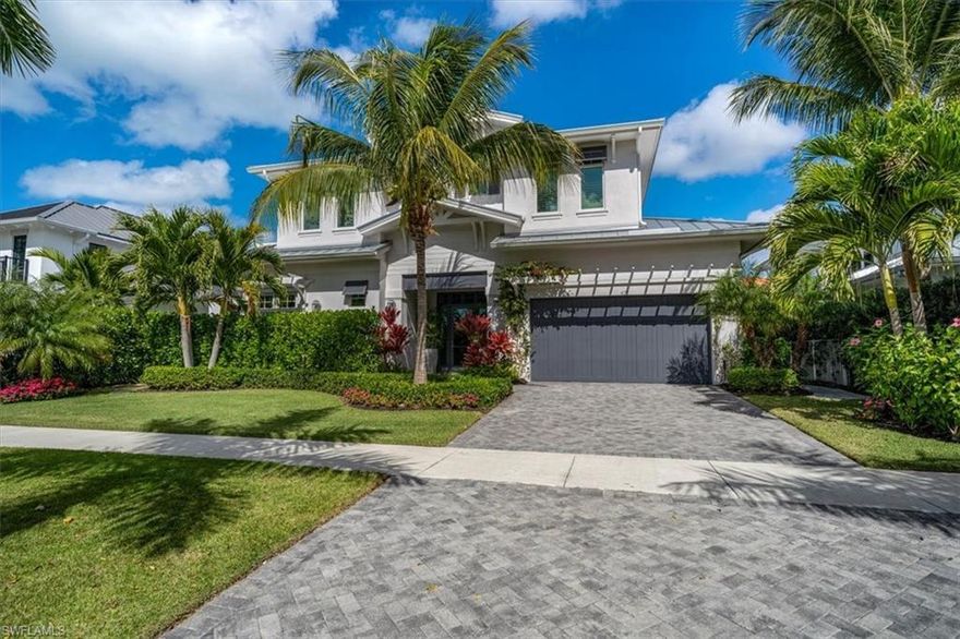 This custom estate designed by Boyatt design and built by DIVCO is situated in a prime location in Olde Naples. Built with sleek elements and an open floor plan design makes this a sought-after gem in the Naples area. Rooms are spacious, and include 5 bedrooms, 5.5 bathrooms, all spread over 3,240 square feet under air and 4,872 square feet total. Upgrades and other room notables are only fitting for a home of this magnitude, and include a modern staircase, 2 sets of pocket sliders, detailed crown moldings and base boards, wood coffered and tray ceilings for added appeal, gourmet kitchen with stainless steel appliances and triple tier custom cabinetry with glass inserts, custom tile and wood flooring, and pocket sliding doors that help bring the outdoor beauty in. The upstairs includes a wet bar with 3 ensuite bathrooms. The lanai is a true retreat, with a large pool and spa, an outdoor kitchen with a BBQ, a large seating area with a pergola, and lush tropical landscaping. This home is within walking distance to 5th Avenue for dining, shopping and the spectacular Naples beaches.