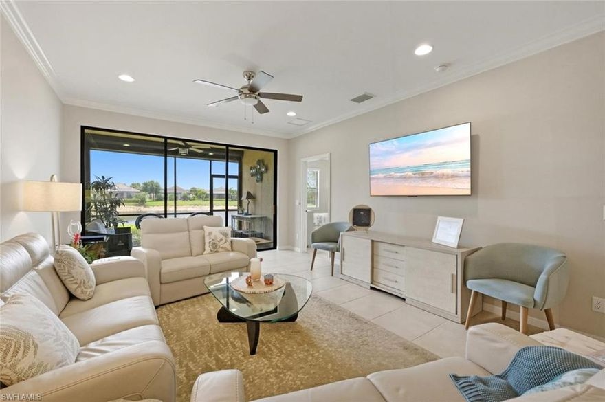 IMMACULATE and exquisitely appointed, this 2 Bedroom + Den, 2 Bath first-floor end-unit residence offering wonderful water views and is gracefully positioned at the end of a quiet cul-de-sac, with convenient guest parking just steps away. LOWEST HOA FEES FOR ALL CONDOS IN ESPLANADE: $350-$400 LESS/QUARTER OR $1400-$1600 LESS/YEAR!  Bathed in natural light, this beautifully crafted 2018 residence features an open, airy floor plan with expansive sliding glass doors that lead to a covered, screened lanai—an inviting retreat for morning coffee or evening cocktails, all overlooking serene lake and preserve views. Ideally situated alongside the community’s scenic walking and biking trails, you can effortlessly explore miles of beautifully maintained pathways winding through lush natural surroundings.
The spacious primary suite is a private sanctuary, offering serene water views, a well-appointed bath, and dual closets that provide both comfort and functionality. The guest bedroom is generously sized and thoughtfully designed as a private en-suite, complete with a custom office/shelving system, as well as ample closet space. The kitchen is both stylish and functional, featuring abundant counter space, an upgraded backsplash, white shaker-style cabinetry, GE stainless steel appliances, and a charming breakfast nook.
The main living area is open and inviting, enhanced by upgraded lighting fixtures and complemented by a versatile den with a window that fills the space with natural light. Currently utilized as a dining area, the den offers flexibility to suit a variety of lifestyles.
Additional highlights include tile flooring throughout the main living areas and den, crown molding in the living room and kitchen, powered hurricane screen in lanai, and a detached one-car carport with a private storage closet.
Residents of Esplanade Golf & Country Club enjoy a nationally recognized, resort-style lifestyle, highlighted by a stunning grand entrance and an exceptional array of amenities. These include a championship golf course, resort-style pool with cabanas and poolside service, Bahama Bar, a beautifully appointed clubhouse with fine dining, tennis and pickleball courts, fitness and wellness centers, a full-service spa and salon, scenic trails, a dog park, and more. Ideally located in North Naples, just minutes from I-75, the airport, premier dining, upscale shopping, and the pristine Gulf beaches.
This property includes a Club/Sports Membership, providing full access to all amenities along with limited golf privileges and two-day advance tee times. Monthly HOA dues cover water, sewer, building insurance, exterior maintenance, etc.  Planned enhancements for 2026 include: Expanded Bahama Bar/Clubhouse Bar, upgraded golf practice facilities and course design improvements, as well as a new indoor pickleball complex featuring 4 air-conditioned courts.
Experience the very best of Esplanade living—where luxury, lifestyle, and location come together seamlessly.