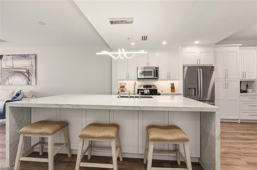 Exceptionally renovated first-floor 2-bedroom, 2-bath condo in Sterling Greens at Glen Eagle featuring peaceful golf course views and a highly desirable southeastern exposure. Enjoy spectacular sunrises and sunshine all day from the screened lanai overlooking the fairway. This residence has been completely renovated—there truly isn’t anything left to do. Updates include new A/C and hot water heater, new appliances, luxury vinyl plank flooring throughout, and a stunning, fully remodeled kitchen with abundant cabinetry, dramatic pompei quartz waterfall countertops, and a designer backsplash. Both bathrooms have been beautifully renovated with high-end finishes as well.  Condos renovated to this caliber are rare so get it before it's gone.