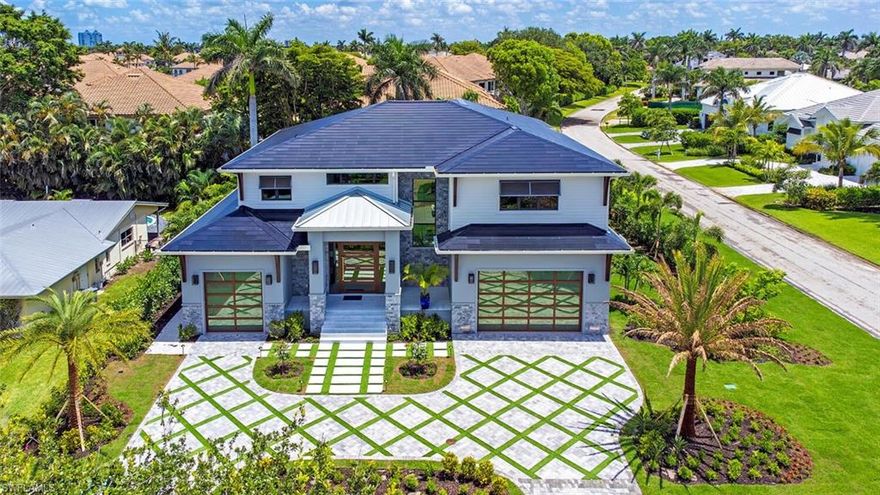 Introducing a distinguished coastal retreat. Beautifully appointed by Clive Daniel and brought to fruition by Poppa Construction, this 6-bedroom plus den residence is a masterclass in modern elegance and refined craftsmanship, nestled in the coveted enclave of Park Shore. Every detail of this home speaks to those with an eye for the exceptional. Showcasing a curated selection of exquisite stone finishes, handcrafted custom trim work, and sleek appliances including the likes of Bertazzoni; the home redefines tasteful selection. A dedicated home office provides a serene space for productivity, while a sprawling bonus room offers endless possibilities for recreation or relaxation. Outfitted with cutting-edge Tesla solar roofing (resulting in zero FPL bill since completion), SPAN smart car chargers, and Control4 whole-home automation, this residence effortlessly merges sustainability with innovation. Whether you're savoring coastal breezes on a nearby beach or enjoying the tranquil sophistication of your personalized living space, this home delivers an elevated Naples experience. Just moments from fine dining, upscale shopping, and Gulf of America sunsets, this architectural gem is the ultimate expression of coastal luxury living — meticulously built for the discerning.