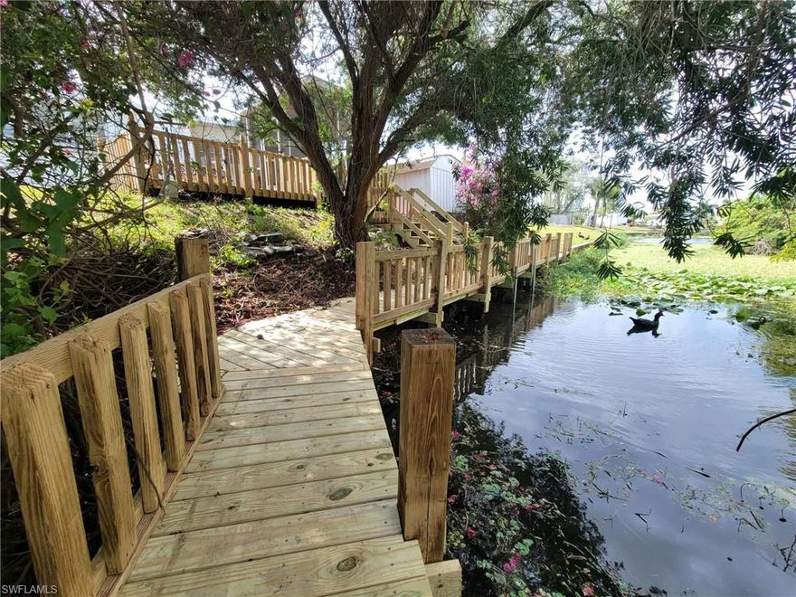 Welcome to your new canal-front home where you own the land with no age restriction nor rent restriction. The beauty of this home comes from the privacy afforded from the large dock up to the personal screened in lanai or stepping out to the deck looking to host a new hot tub! More bonuses outside the home is a storage shed canal side, a tool shed attached to the home creating a 3 sided carport combining the protection of a garage and the breezy feeling of a gazebo. Inside the home we have new vinyl tile in the bedrooms, new paint, new blinds, everything you need for a comfortable move-in. The house is inside of Mobile Manor, which provides access to clubhouse, shuffleboard court, and small parks perfect to walk your dog to for the low voluntary HOA of $27/mo.
