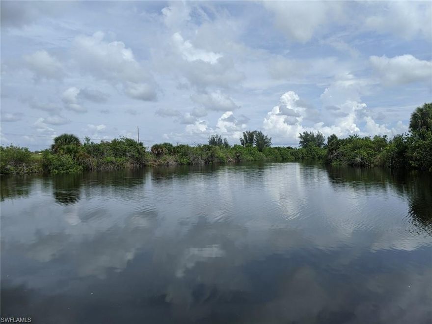 ** NEW CONSTRUCTION GULF ACCESS POOL HOME WITH INTERSECTING CANAL VIEWS ** This 3 bedroom plus den, 3 bath, 3 car garage pool home has over 2100 sqft of living area and is located close to schools, shopping and restaurants. Some of the many features this home has to offer is as follows: Plank tile flooring through out living areas, 5 1/4 baseboards, soft close real wood cabinets with crown molding and light rails, pre wire for above cabinet lighting, a large kitchen island with farm house sink, Quartz counter tops, soaring 12'8" tray ceiling in great room, his and hers walk in closets, dual sink vanity in master, a metal roof, outdoor kitchen with granite countertop (includes sink, fridge and built in grill), paver pool deck and driveway plus a custom heated pool with 360 negative edge spa.