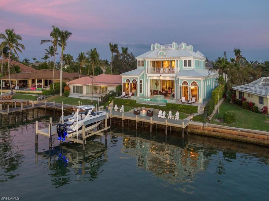 Immaculately maintained one of a kind home has been remodeled with new kitchen, new pool surface & glass tiles, dock fire pit, driveway and entry, master tub & more. Decorated by Ficarra Design this is an entertainer's dream! Residence features huge chef's kitchen w/top of the line appliances, gas stove, double oven, 2 dishwashers, 2 ice machines, over-sized refrigerator & 1,500 bottle, temp. controlled wine cellar w/computerized catalog & scanning system! All 4 bedrooms feature their own en-suite bath. Huge master suite consists of exercise room, private office & French doors opening to private balcony that over-looks the bay. Master bath has modern soaking tub & spa-shower w/Grohe temp settings. Hickory hardwood flooring, extensive trim package, faux painting, plantation shutters & extensive upgraded sound/security/camera/audio visual control system can be found throughout. Entertaining has never been easier w/expansive outdoor living space including, summer kitchen, outdoor fire pit, sun deck & saltwater infinity edge pool/spa w/new gas heater. Newly extended dock has 27,000 lb boat lift w/Snook lights & fish cleaning station, perfect for all your boating needs!