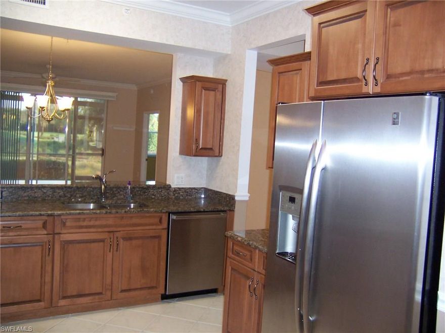 Gorgeous Kitchen and Spectacular views from this lovely 1st fl Social garden home with updated kitchen boasting Cherry Cabinets, Stainless Steel Appliances, Granite, Crown Molding, custom window cornices and extra 42" cabinets for additional storage. A/C & WATER HEATER 2013, berber carpet, diagonal tiled Living room, tinted glass and enclosed tiled lanai with stunning water and golf course views!! Storm Shutters and ADT alarm system will give you  peace of mind when you're home or away. Large Master bedroom with sitting area and plenty of windows to enjoy the gentle breezes beautiful Florida offers. Spacious master bath with separate his and her sinks, soothing garden tub and separate shower. Located on a peaceful street with off street parking. The Legends is a Prestigious Resort Style Country Club offering 7 har tru tennis courts, exercise facility w/ tons of classes, 4 boccee ball, 30,000+ clubhouse offering fine dining and casual sports pub along with outdoor terrace/bar and a huge lagoon style pool with a water fall. Great location.. Close to shopping, dining, the airport and entertainment. Resort Style living to it's finest waiting for you to call it home!!