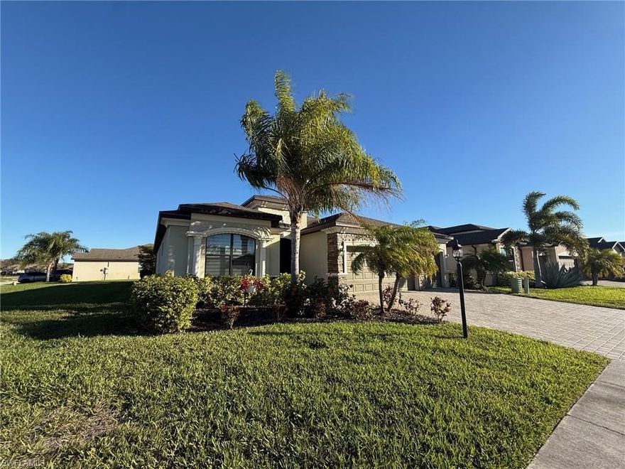 Seller motivated and offering $10,000 closing cost credit — excellent opportunity for buyers needing assistance with cash to close!  Beautiful 4BR/2BA/3-car garage home built in 2018 with an oversized corner lot with peaceful lake views. Great open room layout features tile flooring, crown molding, tray ceilings, and both formal and casual dining areas. Remodeled modern kitchen offers quartz countertops, stainless steel appliances, wall oven, farm sink, and large new pantry. Spacious primary suite includes patio access, sitting area, walk-in closet, electronic shades, and spa-style bath with dual sinks, soaking tub, and walk-in shower. Enjoy the extended lanai with screened patio, pergola, and full outdoor kitchen overlooking the lake — ideal for entertaining. Spacious primary suite includes patio access, sitting area, walk-in closet, electronic shades, and spa-style bath with dual sinks, soaking tub, and walk-in shower. Additional highlights include paver driveway, laundry room with sink and cabinets, no flood insurance required, low HOA, and resort-style amenities. Convenient location near I-75, 10 minutes from downtown Fort Myers, shopping, and dining. Move-in ready!!