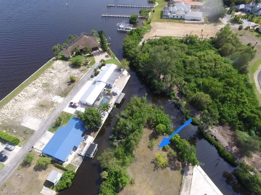 Imagine having a HALF ACRE building lot with 350 linear Feet of water frontage… just 50 feet from the Caloosahatchee River.  It is Mere minutes to open water from your intersecting canal.  This Penisula shaped property feels like you are secluded, yet in an established, private neighborhood. The lot has been cleared.  Two lots were strapped together as one, but could easily become 2 addresses again.  Convenient to everything yet located at the end of a Private, Quiet Road, there is no through traffic.  This could be the ideal spot to build your dream home or multi-family home and have plenty of land to grow.  NO HOA, County taxes only.