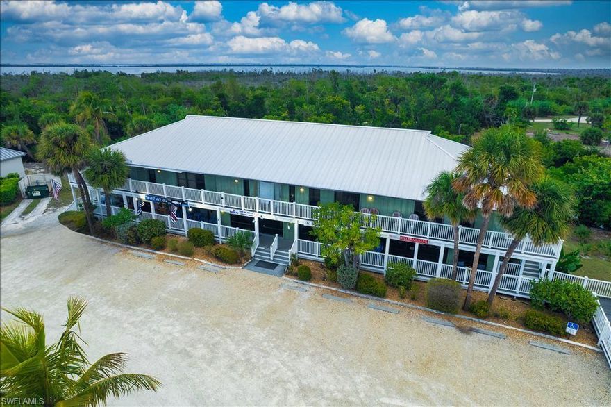 Income-producing two-story commercial building in the heart of Sanibel’s Central Business District, offering 175 feet of prime Palm Ridge Road frontage and outstanding visibility. Zoned Town Center Limited, the preferred location for retail and mixed-use opportunities, and is designated G (Altered Lands) under the City of Sanibel Comprehensive Land Use Plan.   The fully leased first floor provides immediate, stable cash flow, while each level offers 4,066 square feet of space. Constructed with steel-reinforced concrete slab and concrete stem wall footings for long-term durability and low maintenance. The second floor presents future residential potential, with architectural plans already prepared and subject to City approval—creating meaningful value-add and additional income upside. A strategic opportunity to secure high-visibility Sanibel commercial real estate with both current performance and long-term growth potential.  Building currently being repainted & doors replaced on second floor.