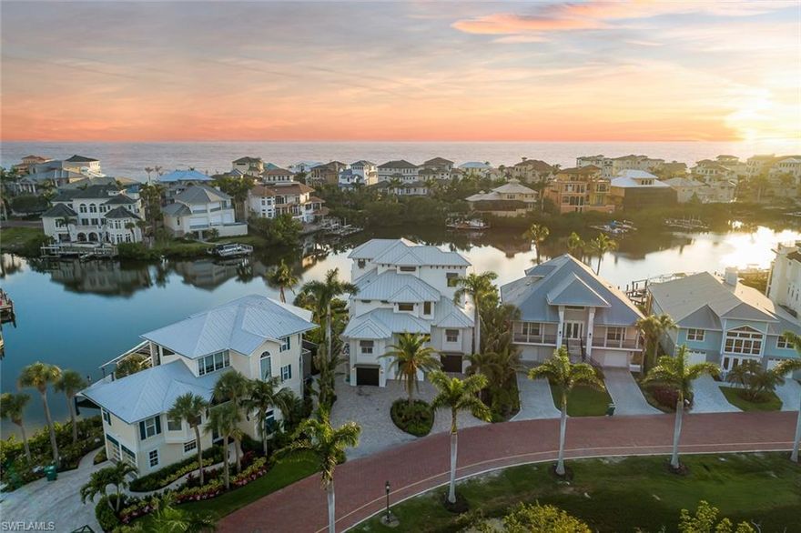 H10607  Spectacular, Bayfront home, with wide water views, located in the double-gated “Bayfront” neighborhood of Collier County’s “Barefoot Beach”. Just completed in 2018, this 5,648 sq ft luxury home was reengineered down to the shell & rebuilt including a new roof, impact glass windows/doors, brand-new 10,000 lb boat lift & more. Offers breathtaking wide bay views from nearly every window & Western exposure for magnificent sunsets over the pool with an outdoor kitchen. Only a 5-minute walk to the deeded resident beach access or a 15-minute boat ride to the Gulf from your new boat lift. This coastal contemporary masterpiece features an open floor plan, wide plank oak floors, elevator, generator & a top-level cloud room with a morning bar, full bath & balcony.  Spacious chef’s kitchen has an 11 ft. island, granite counters, custom cabinetry, high-end appliances, a gas range & a wet bar with wine fridge. Private master suite is located on its own floor & offers a waterfront balcony, walk-in closet with private laundry & an oversized spa-like en suite bath. Bayfront Dr. homes are built on one side of the street with a preserve on the other side, providing homeowners optimal privacy.