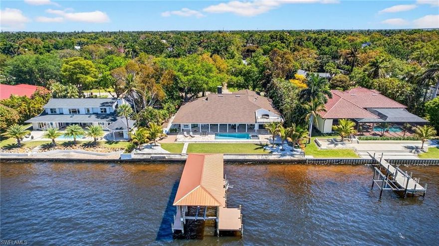 Experience refined waterfront living with direct Gulf access and desirable westward exposure for stunning sunset views, all set in a quiet, charming neighborhood. This spacious 5-bedroom, 5 full bath home also features a large den/office with built-in workspaces, and offers a thoughtfully designed layout that blends elegance, comfort, and functionality. Inside, you’ll find high-gloss porcelain and travertine flooring, soaring ceilings, and a striking stone accent wall with fireplace and chimney that creates a warm yet sophisticated first impression.

At the heart of the home is a chef’s dream kitchen appointed with Taj Mahal quartzite countertops that light up at night, custom cabinetry, high-end Sub-Zero & Wolf appliances, and generous prep space, along with a convenient butler’s pantry, providing additional storage and preparation area for entertaining. A climate-controlled wine cellar room is designed to properly store your collection, while the spacious movie and game room includes its own kitchen and bar area, perfect for gatherings and recreation.

Step outside to your private waterfront oasis featuring a resort-style pool and spa, fire pit, spiral staircase leading to a private balcony overlooking the river, and a metal-covered boat dock with lift along the river, offering quick and easy Gulf access. Each of the five spacious bedrooms includes its own en-suite bath, and the dedicated office provides an ideal work-from-home retreat.

With a three-car garage, ample additional parking, and a prime location near fine dining, shopping, top-rated schools, and the beaches of Southwest Florida, this is a rare opportunity to own a luxury riverfront estate with Gulf access in one of Fort Myers’ most desirable settings.