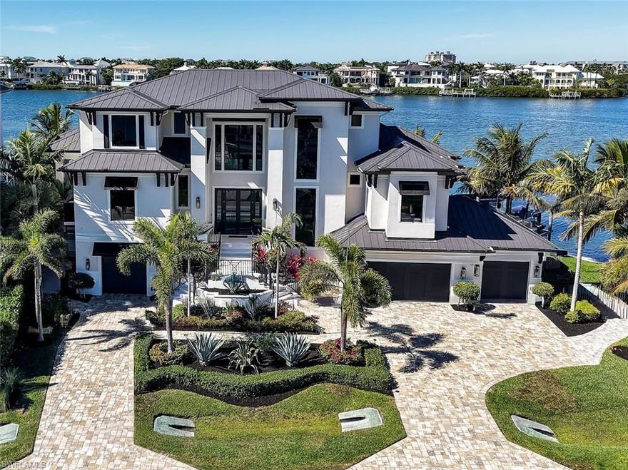 BOATER'S DREAM... Here’s your unique opportunity to own a GULF ACCESS PROPERTY ON LITTLE HICKORY BAY IN BONITA SPRINGS WITH NO BRIDGES AND NO HOA FEES!  This coastal-designed contemporary home encompasses panoramic views and beautiful sunsets with approx. 180’ of waterfront with a curved seawall overlooking the widest part of the bay facing Barefoot Beach & the Gulf of Mexico to the west.  This is a multi-level 5 Bedroom Ensuite 5.5 Bath home designed with expansive outdoor living areas, covered patios, motorized shutters and screens.  It incorporates an open floor plan with cathedral ceiling in the great room, gas fireplace and is equipped with Andersen impact windows and doors, chef’s kitchen with island for gathering, Subzero and Wolf appliances, quartzite countertops, dual laundries, elevator, tankless gas hot water, perimeter camera security, outdoor living area with fireplace, infrared heated yoga room, infinity edge pool and spa, fire pit, private boat dock and dual jet ski lift, 4-car garage, electric vehicle charging, Aquasana whole house water filtration system and many upgrades to meet the needs of the most discerning tastes. The home was built to the most stringent Collier County building codes with concrete block & frame construction.  The boat lift is a 20,000 lb. 8 pole, 4 motor system with roof including garage overhead and dock lighting, dual jet ski lift, two hose water system for engine flushing and boat cleaning at the same time. The property is located in Collier County with central water & sewer.  Located 1.7 miles from beaches, convenient to Coconut Point Mall, Mercado and Waterside with close proximity to SWFL Intl Airport and FGCU.