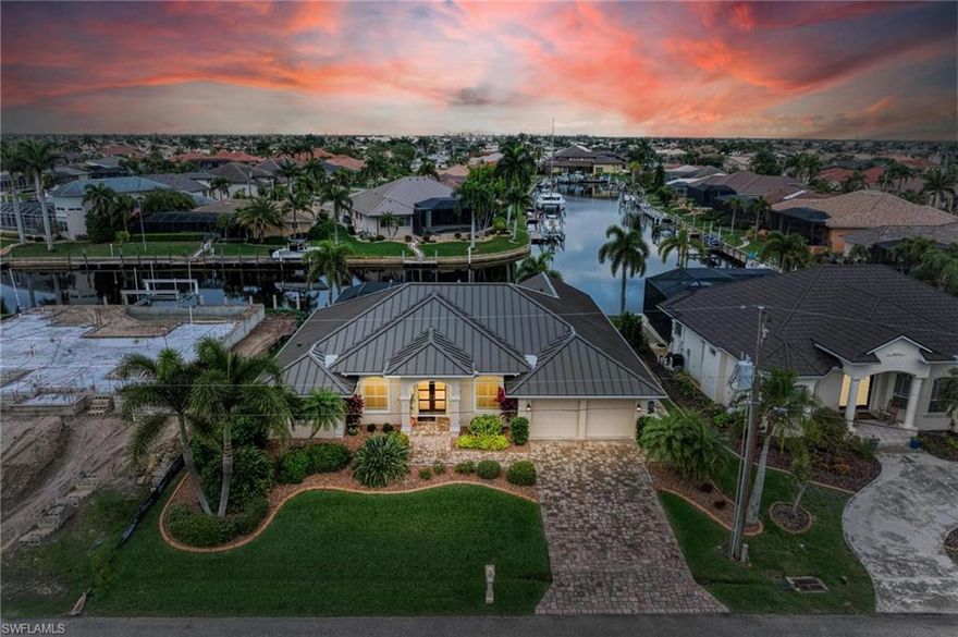 UNBELIEVABLE VALUE FOUND IN THIS BEAUTIFUL WATERFRONT POOL HOME WITH 75' Concrete Dock with 7' DRAFT (Dredged for Large Yacht), 5 Minutes to Charlotte Harbor with NO BRIDGES, a NEW STANDING SEAM METAL ROOF, FULL HURRICANE PROTECTION, UPGRADES including full real wood custom cabinetry with soft close and pull out drawers, quartz counters, plantation shutters or Hunter Douglas Luminette blinds throughout, 2 updated TRANE AC units with fresh air exchangers, whole home water filter system, updated pebble tech finish on pool, and many more beautiful updates!  From the exterior, enjoy a paver driveway with upgraded landscaping and beautiful curb appeal, noticing the new metal roof. Enter the custom glass doors to the large foyer open to the formal dining room with cove lighting/tray ceilings to the right and the large great room w a large electric fireplace with back LED lighting, with custom stone/tile work and beautiful pool and long water views beyond the pocket sliding glass doors! To the left of this area is a potential 4th bedroom, currently used as an office with built in cabinetry, and the spacious primary suite that takes up the entire left side of the home! The bedroom is spacious and has lovely water views and a seating area, along with dual walk-in closets, a private toilet/sink area & dual sinks, a separate soaking tub and glassed shower, recently remodeled.  On the opposite side of the great room, enjoy an updated kitchen, also with updated cabinetry with glass fronts, Bosch & Kitchen Aid appliances, a large breakfast bar, and beautiful dinette area overlooking the water.  On the right side of the home, find a large 2 car garage with epoxy flooring and extra cabinetry/storage, and a FABULOUS layout, with two large guest bedrooms with a shared updated guest bathroom near the exterior door leading to the pool, and a HUGE den with windows overlooking the long water view and sliding door access to the pool.  The laundry room is also tucked away in this area.  Outside enjoy a spacious covered lanai that has electric roll down hurricane shutters for convenience, an remodeled pool/spa with upgraded finish & variable speed pump. Down at the dock prepare to be WOWED with the best large vessel dockage in Punta Gorda Isles including a Keesling dock with extra tall concrete pilings, water & 30 & 50 AMP service, a heavy duty Slidemoor system, and extra deep dredging, with a 75' dock and 85' of city maintained concrete seawall, minutes to open water!  This home has it all and is priced to sell, nearby to all things Punta Gorda, including great golf, shopping, restaurants, the PGD airport, and more! Be sure to ask for full features sheet Schedule your showing today! BE SURE TO CLICK THE FULL VIRTUAL TOUR LINKS FOR DETAILS!