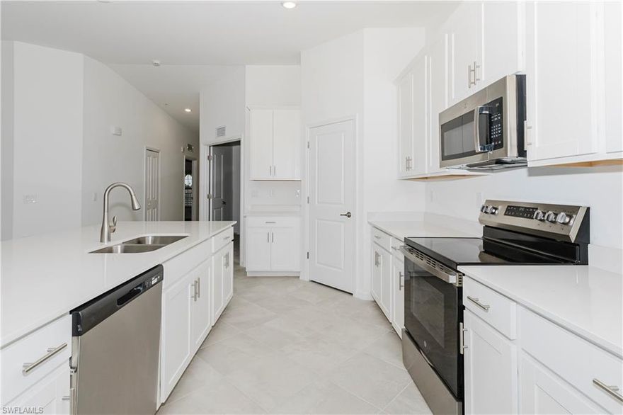 Beautifully appointed 2 bed + den, 2 bath Veranda condo. This 2nd-floor residence boasts vaulted ceilings, an open-concept design, split bedrooms, and a spacious kitchen with quartz countertops, stainless steel appliances, and a large island. Two screened lanais—front and back—offer serene golf course views and the perfect spaces for relaxing or entertaining. A social membership is included, granting access to resort-style amenities such as the pool, fitness center, tennis, pickleball, spa, clubhouse dining, and more. Live the ultimate Florida lifestyle in one of Southwest Florida’s most desirable golf communities, The National Golf & Country Club at Ave Maria. Discover for yourself why the locals say, “Ave Maria—once you get here, you get it!”